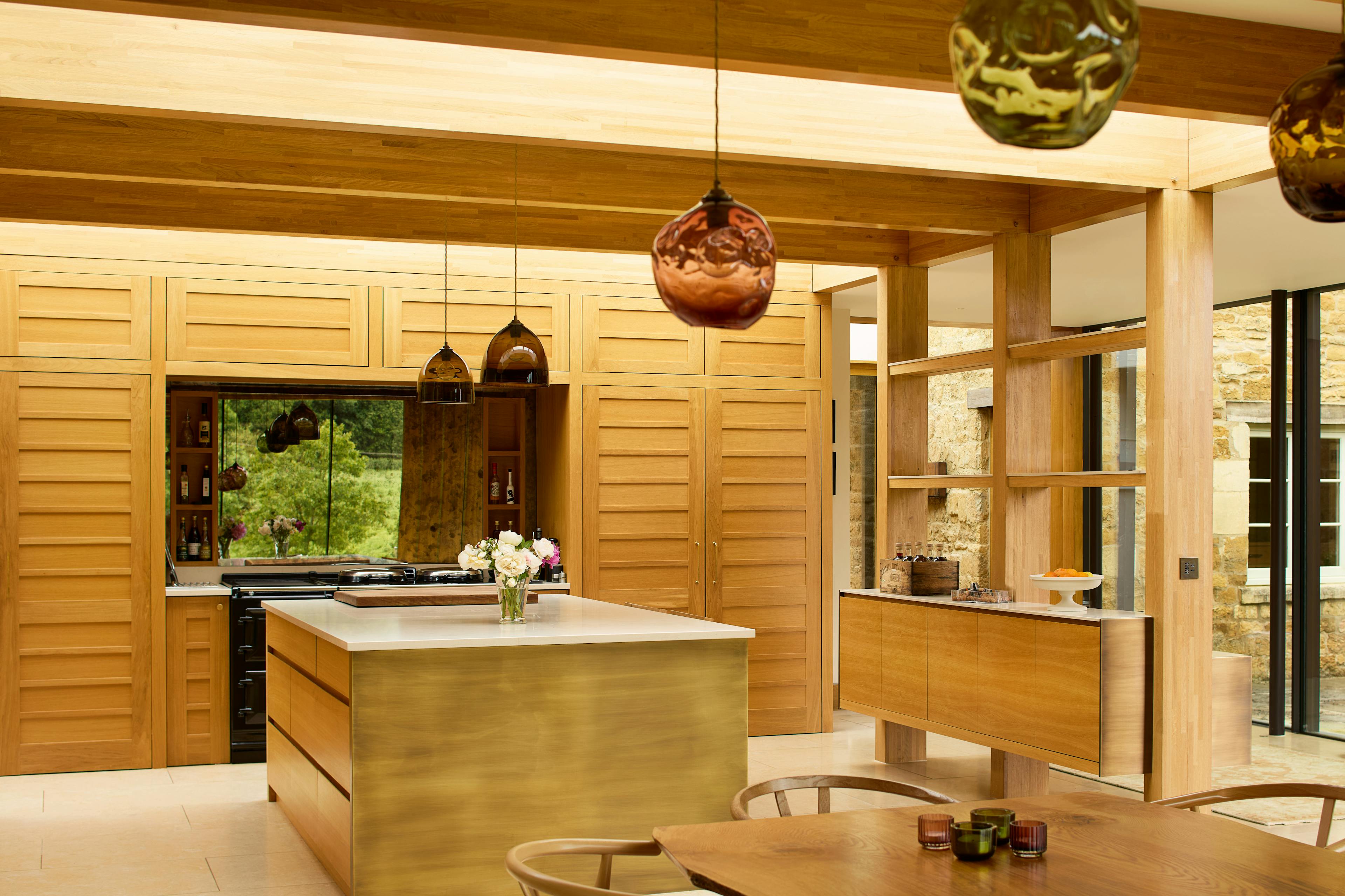 The open plan kitchen and dining area of an oak glulam extension to a listed manor house