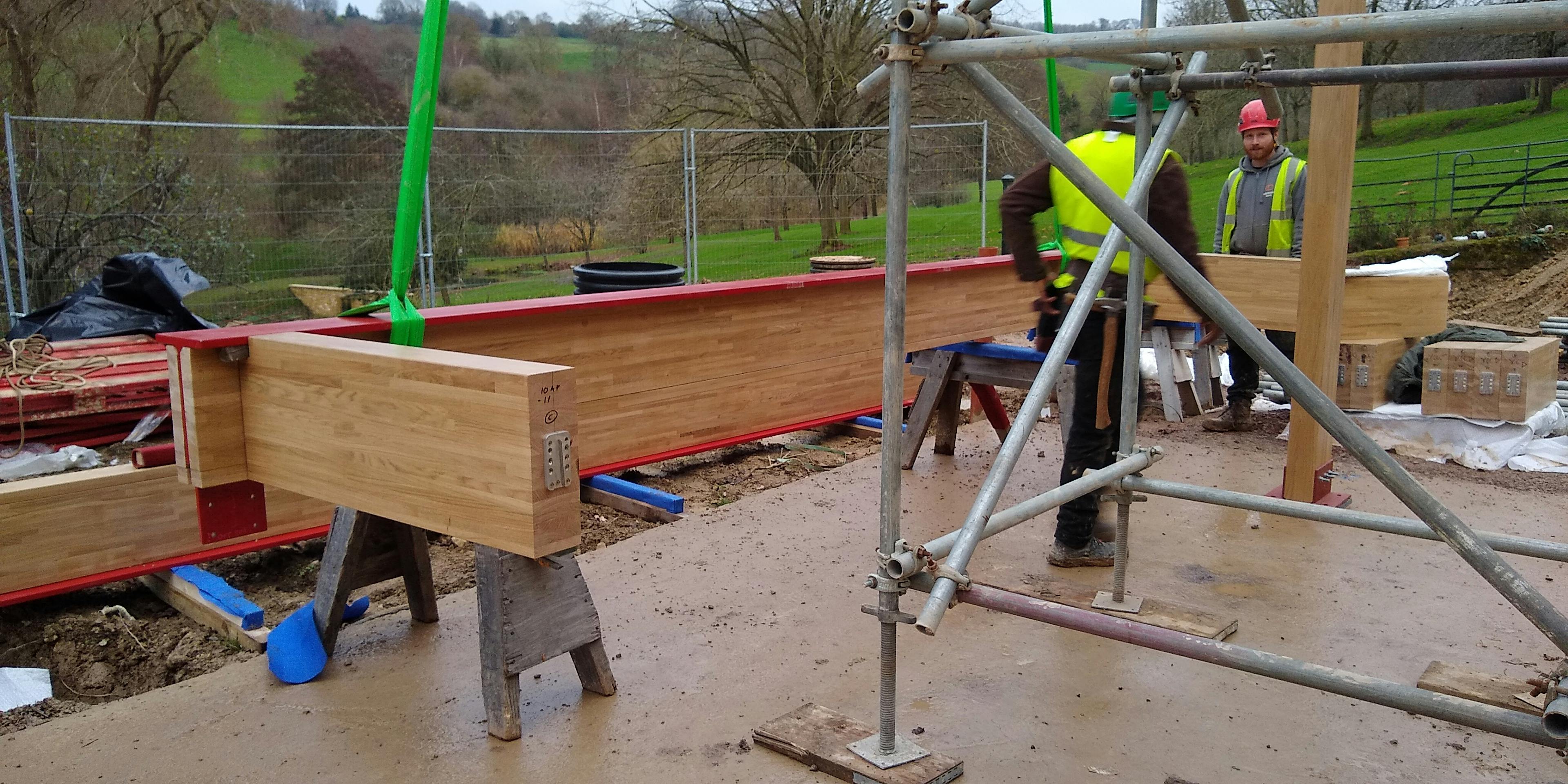 Carpenters working on a frame installation of an oak glulam extension