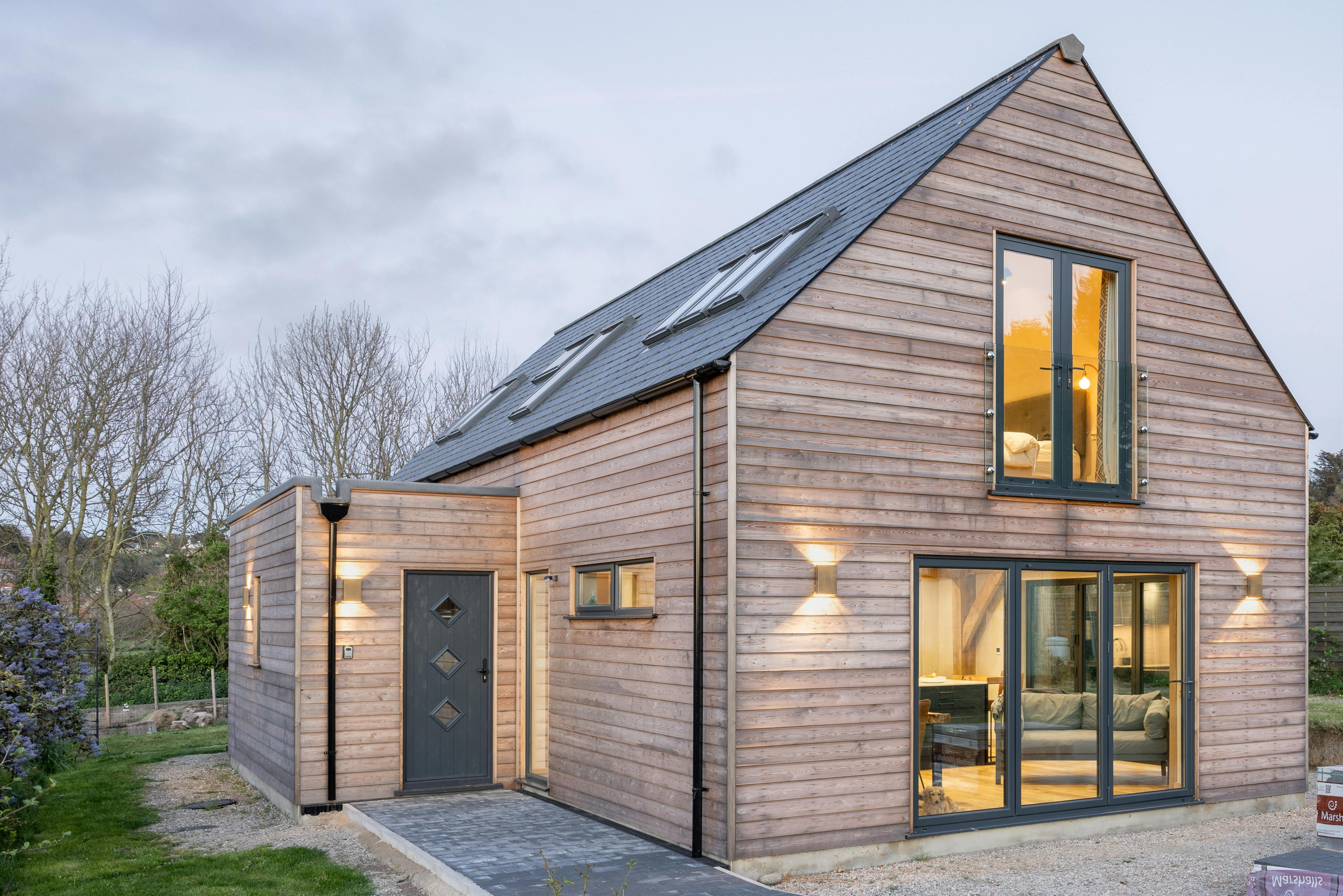 A timber clad two storey oak framed home