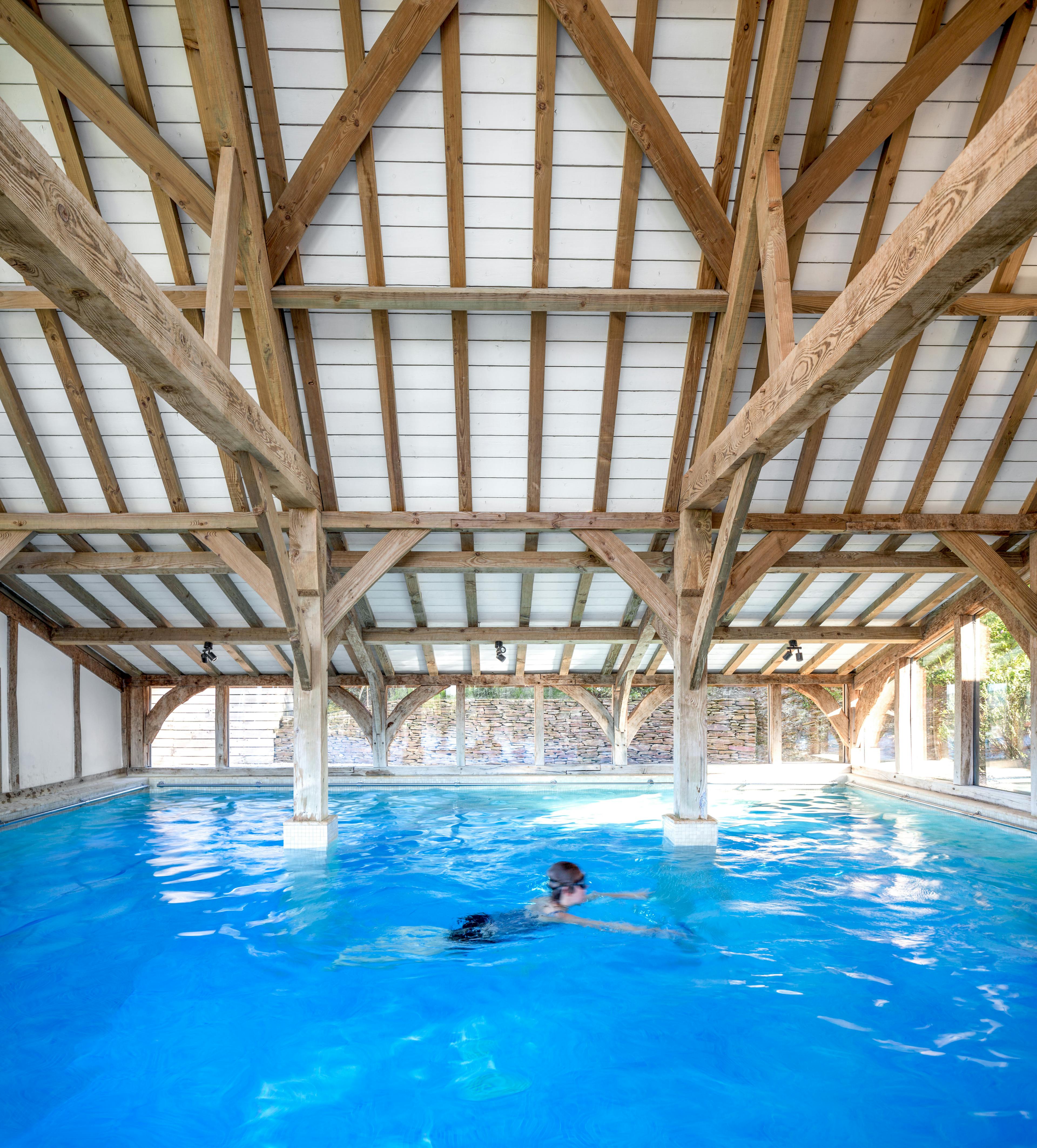 A large oak framed swimming pool building enclosure