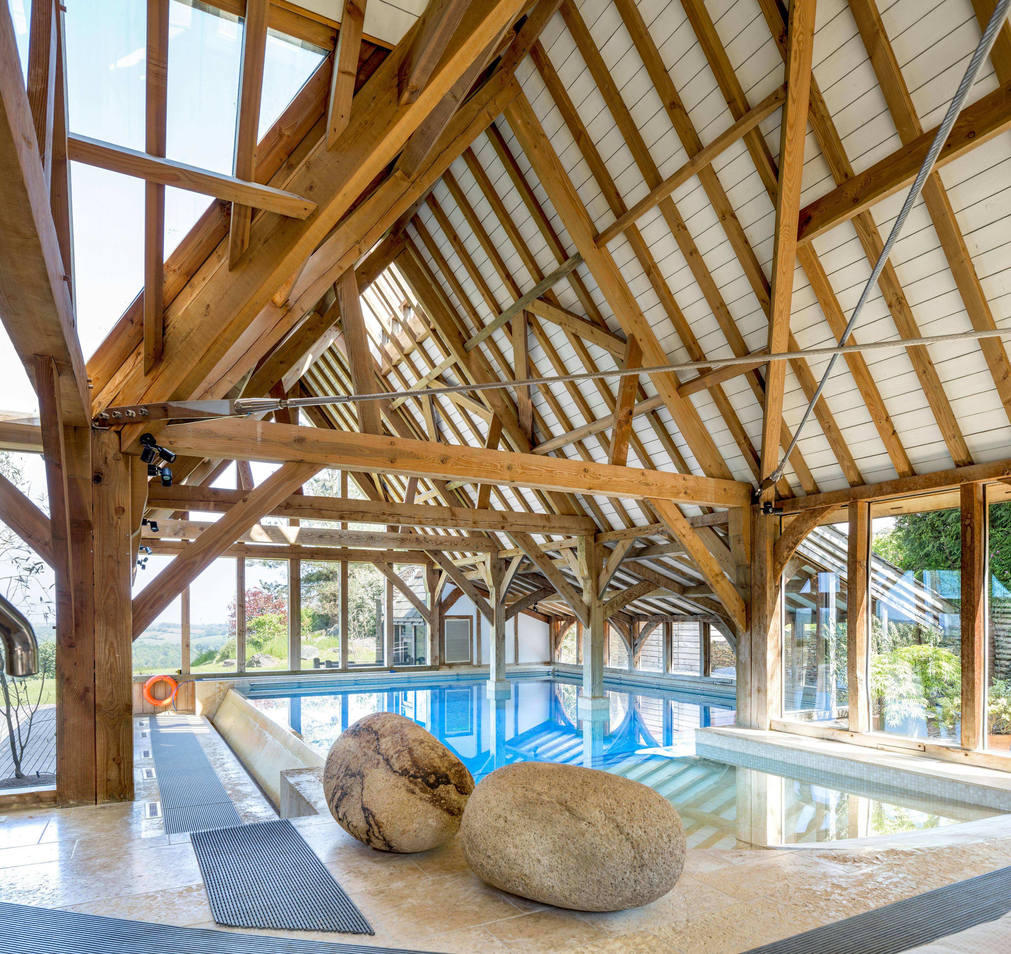 A large oak framed swimming pool building enclosure