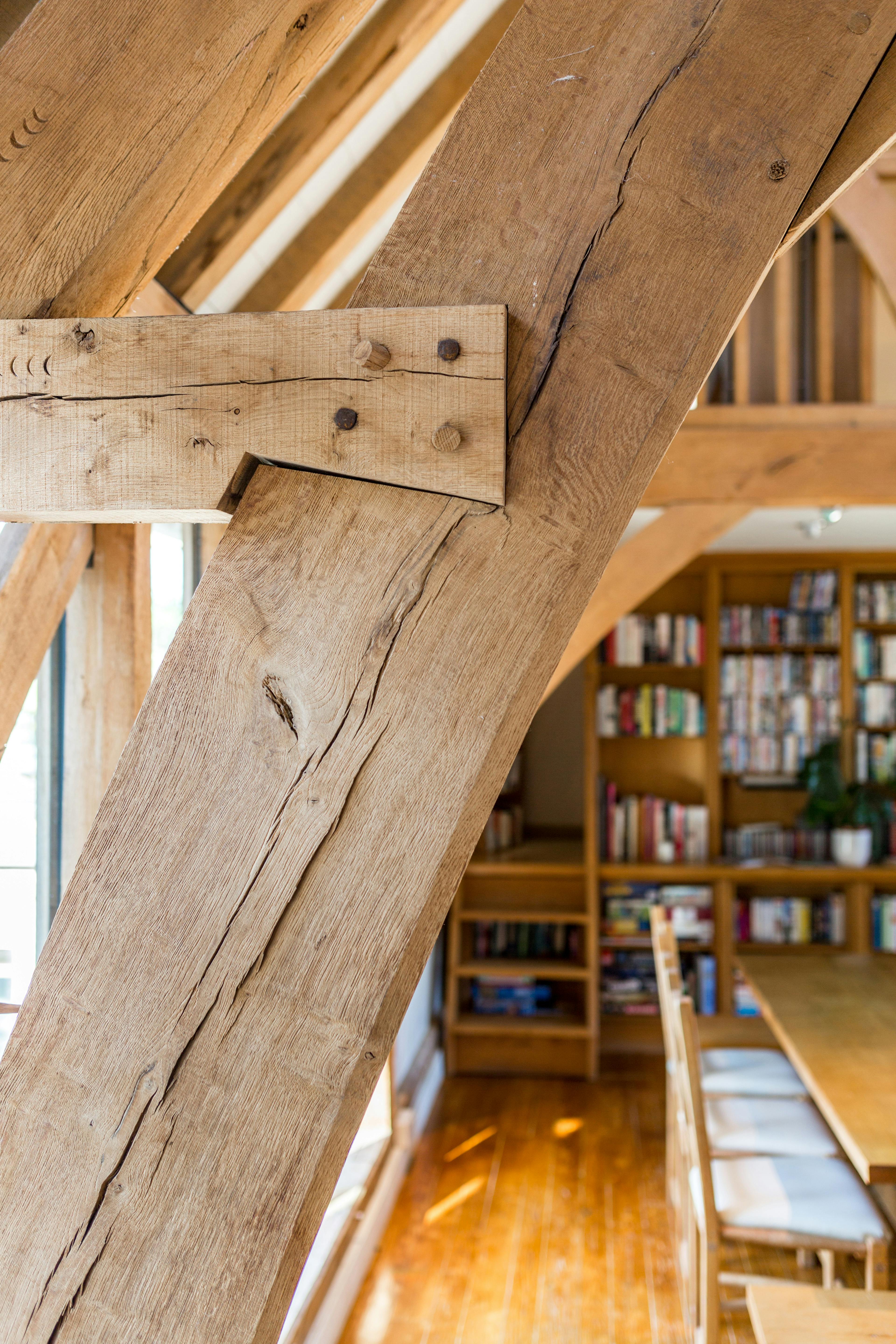 A large living room with an oak frame cruck truss vaulted ceiling