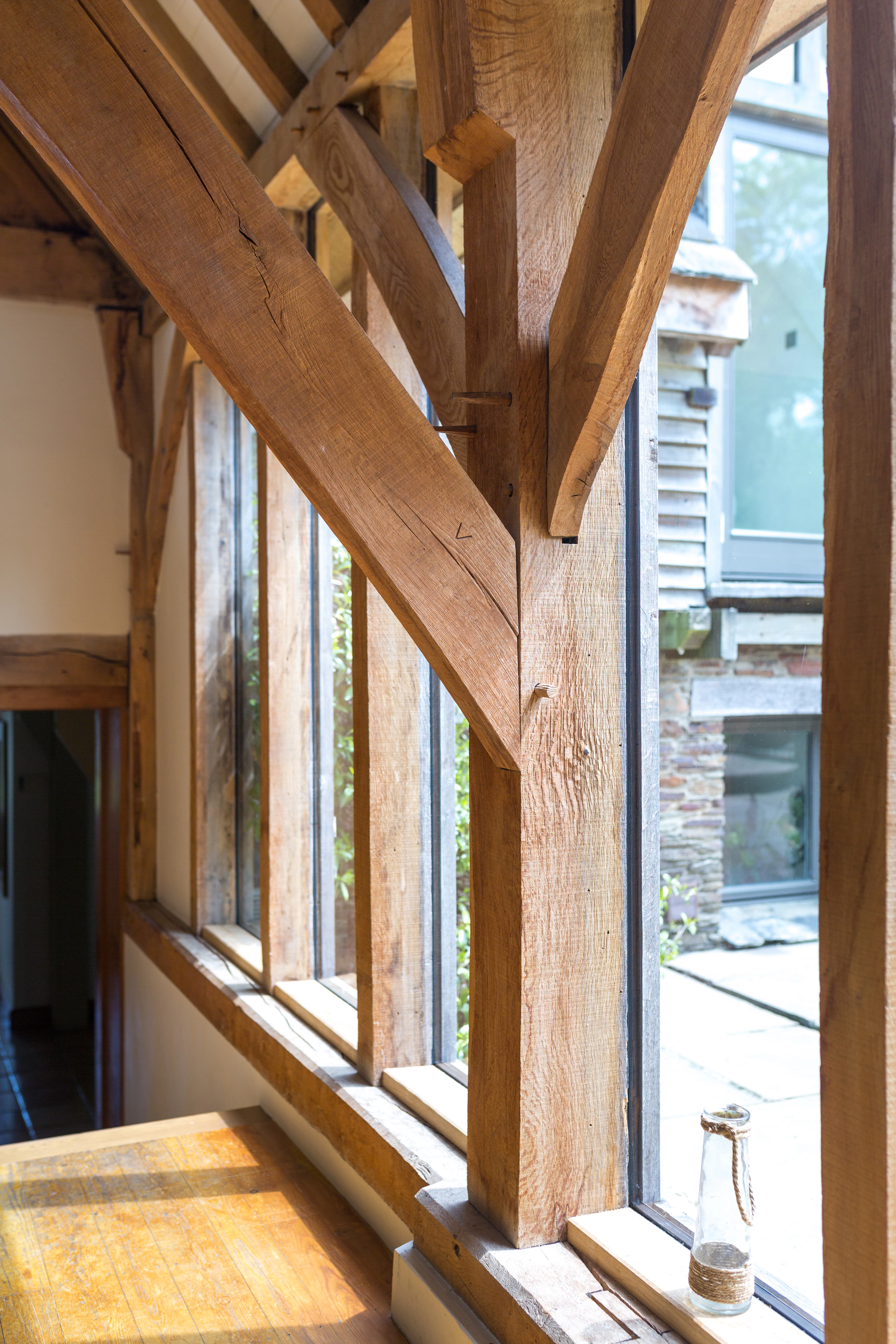 An oak frame post with a complicated joining of posts