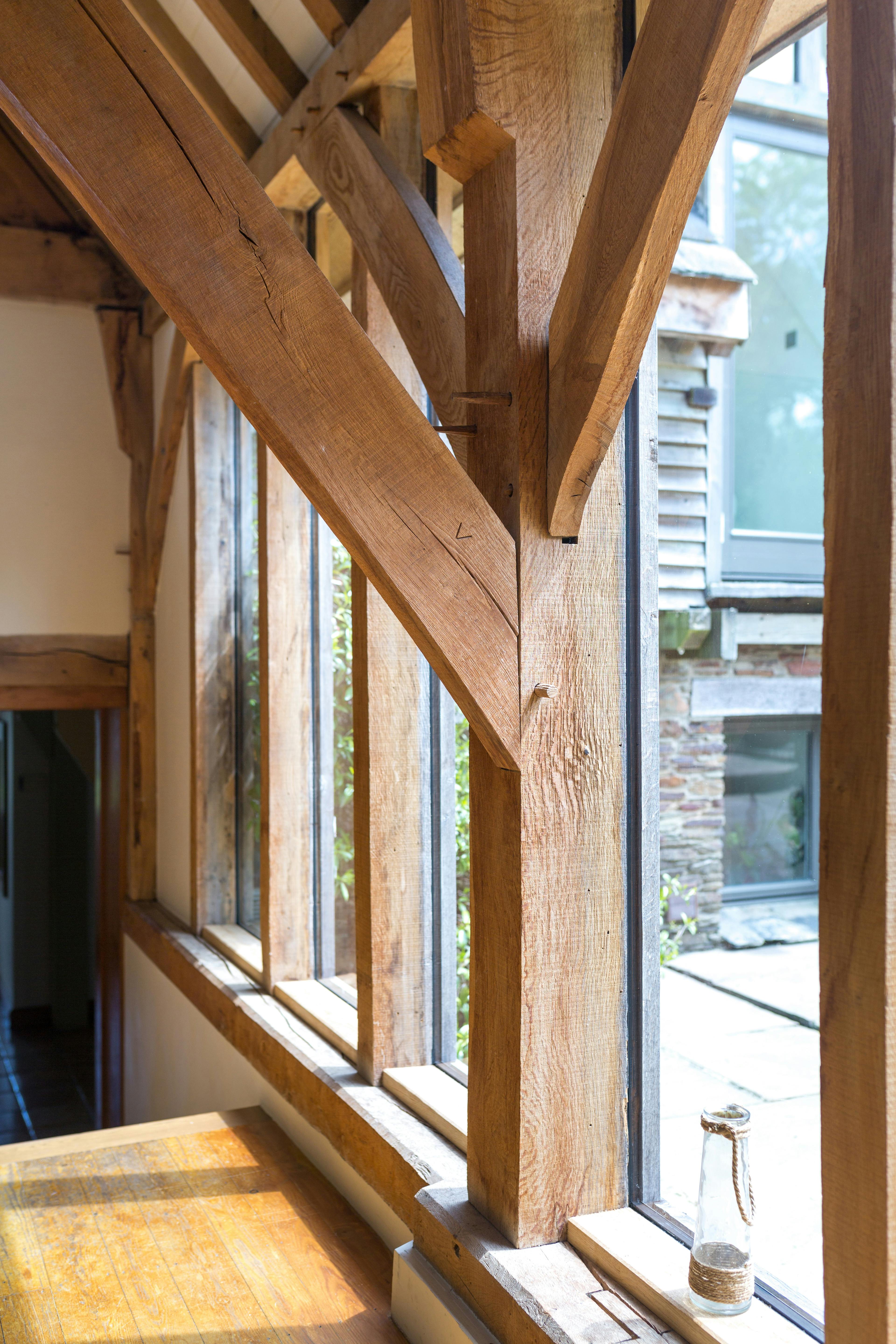 An oak frame post with a complicated joining of posts