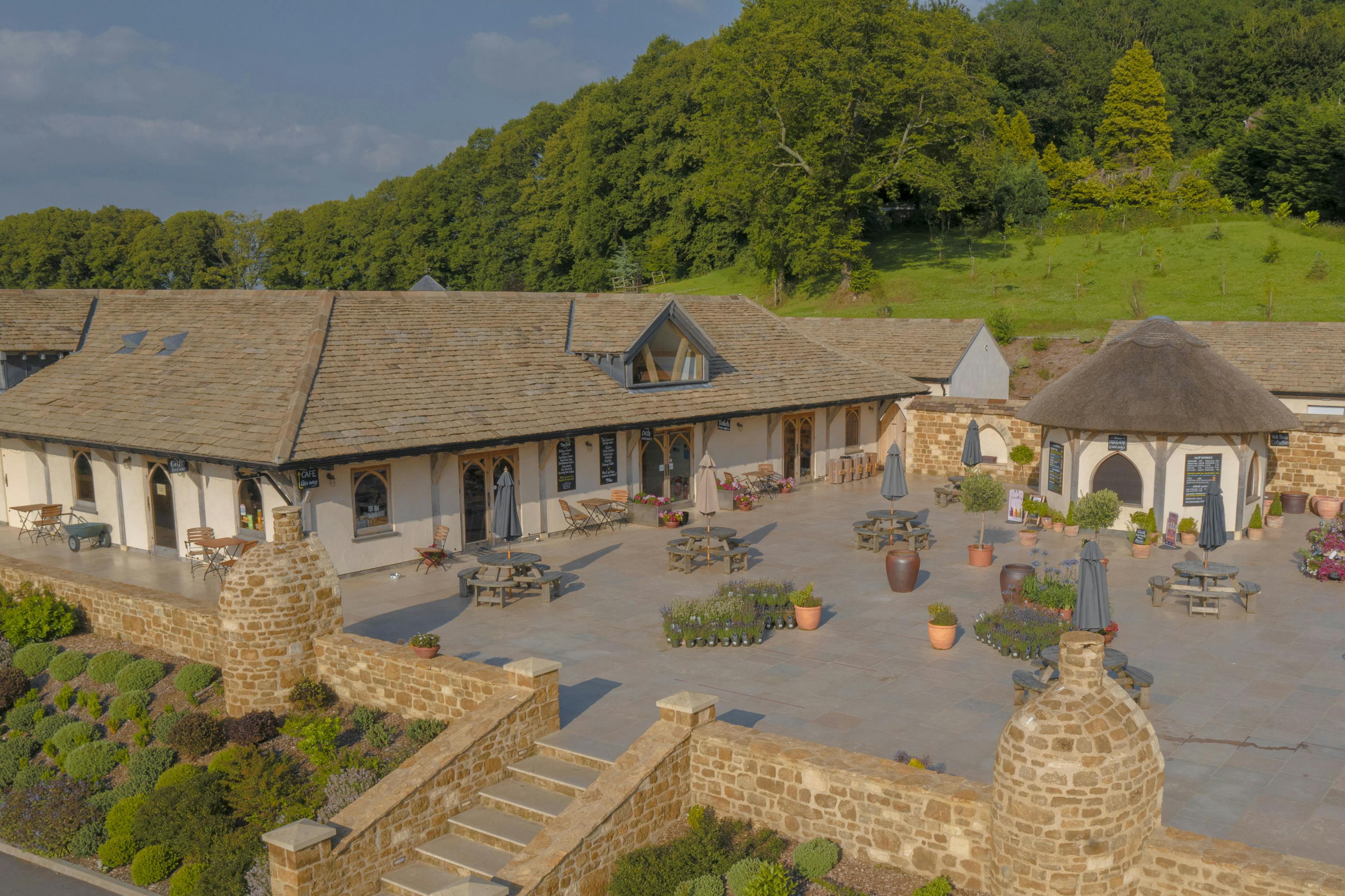 Oak framed garden centre and cafe with a large paved courtyard