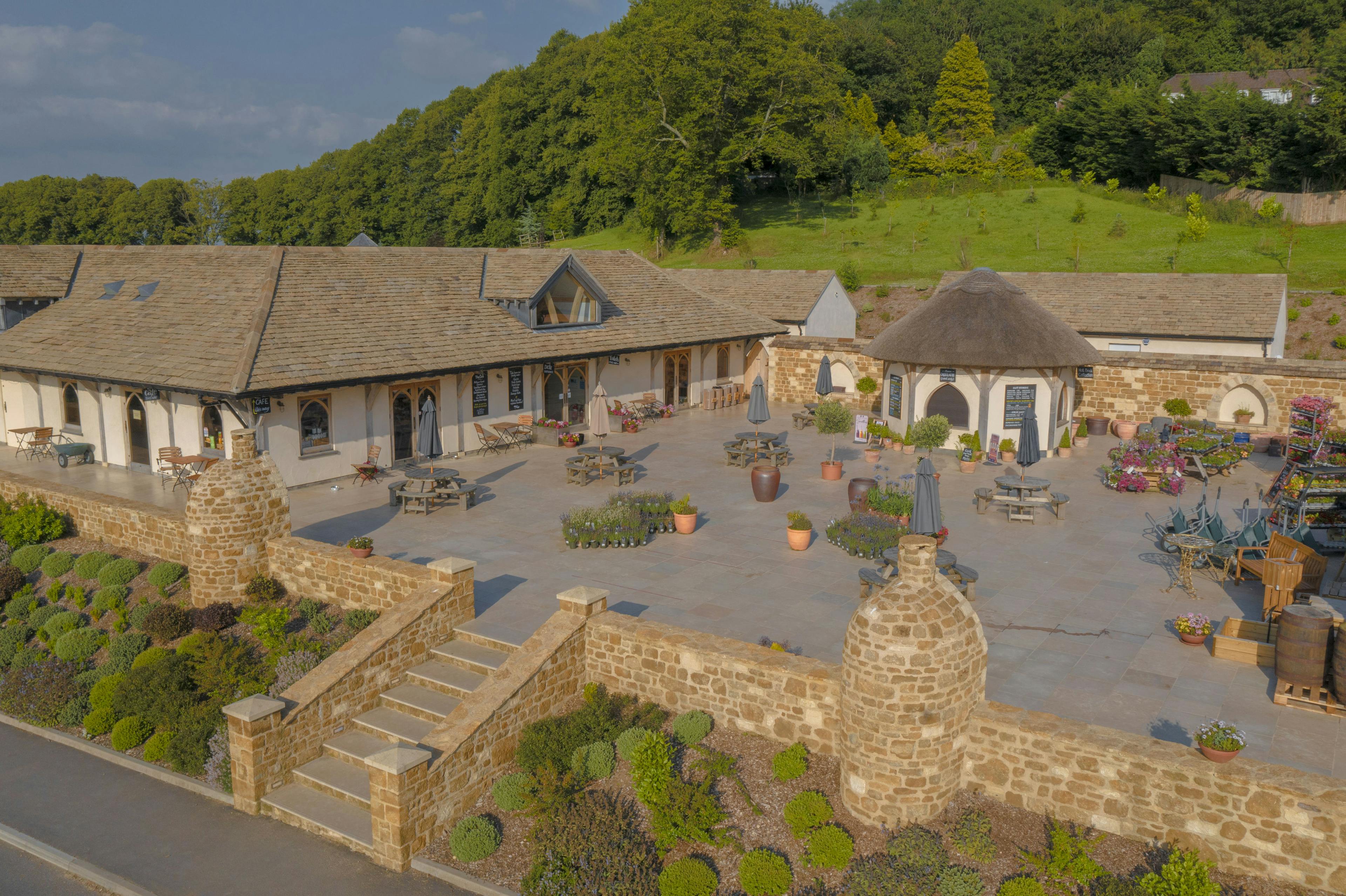 Oak framed garden centre and cafe with a large paved courtyard