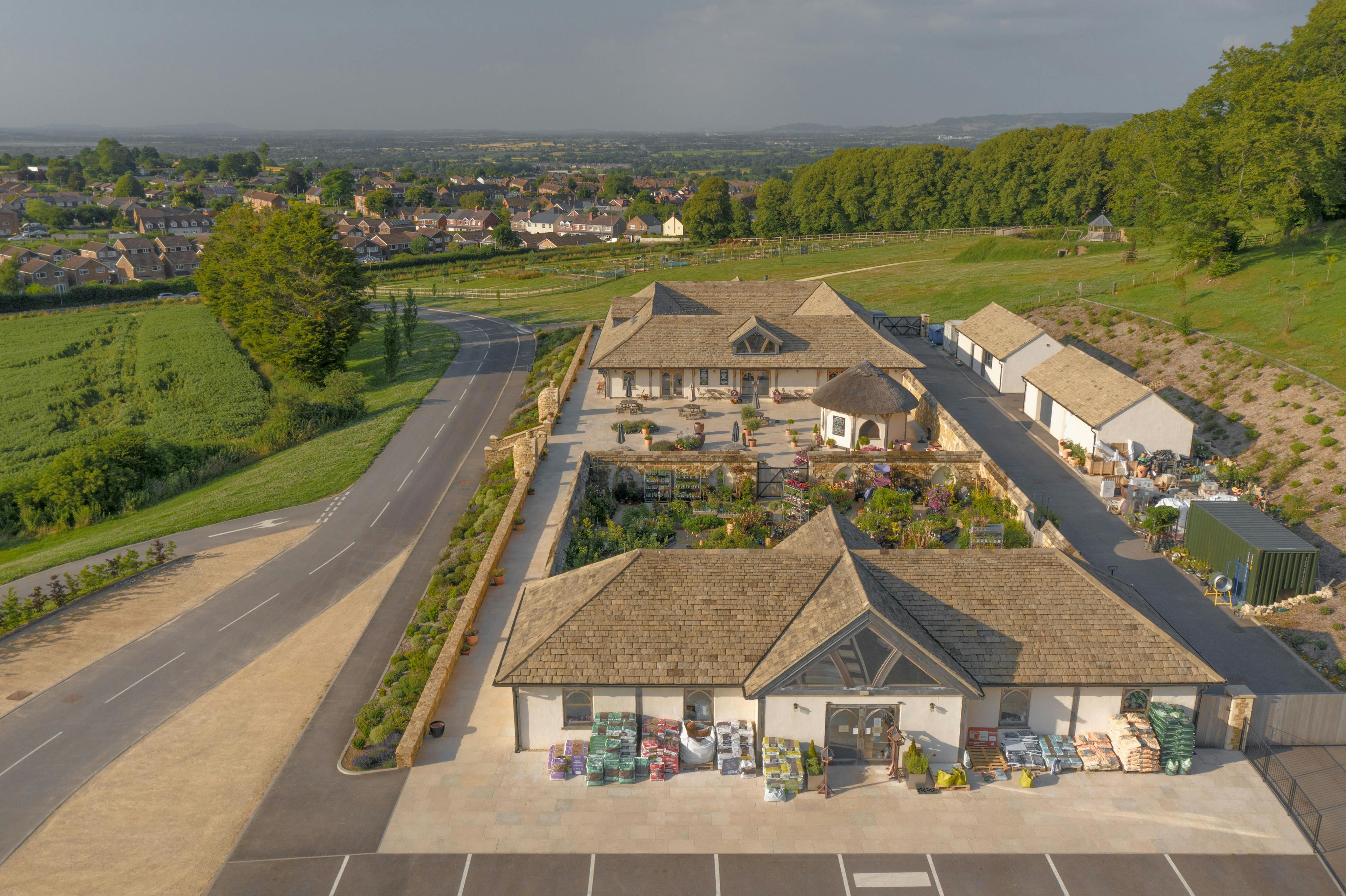 Oak framed garden centre and cafe with a large paved courtyard