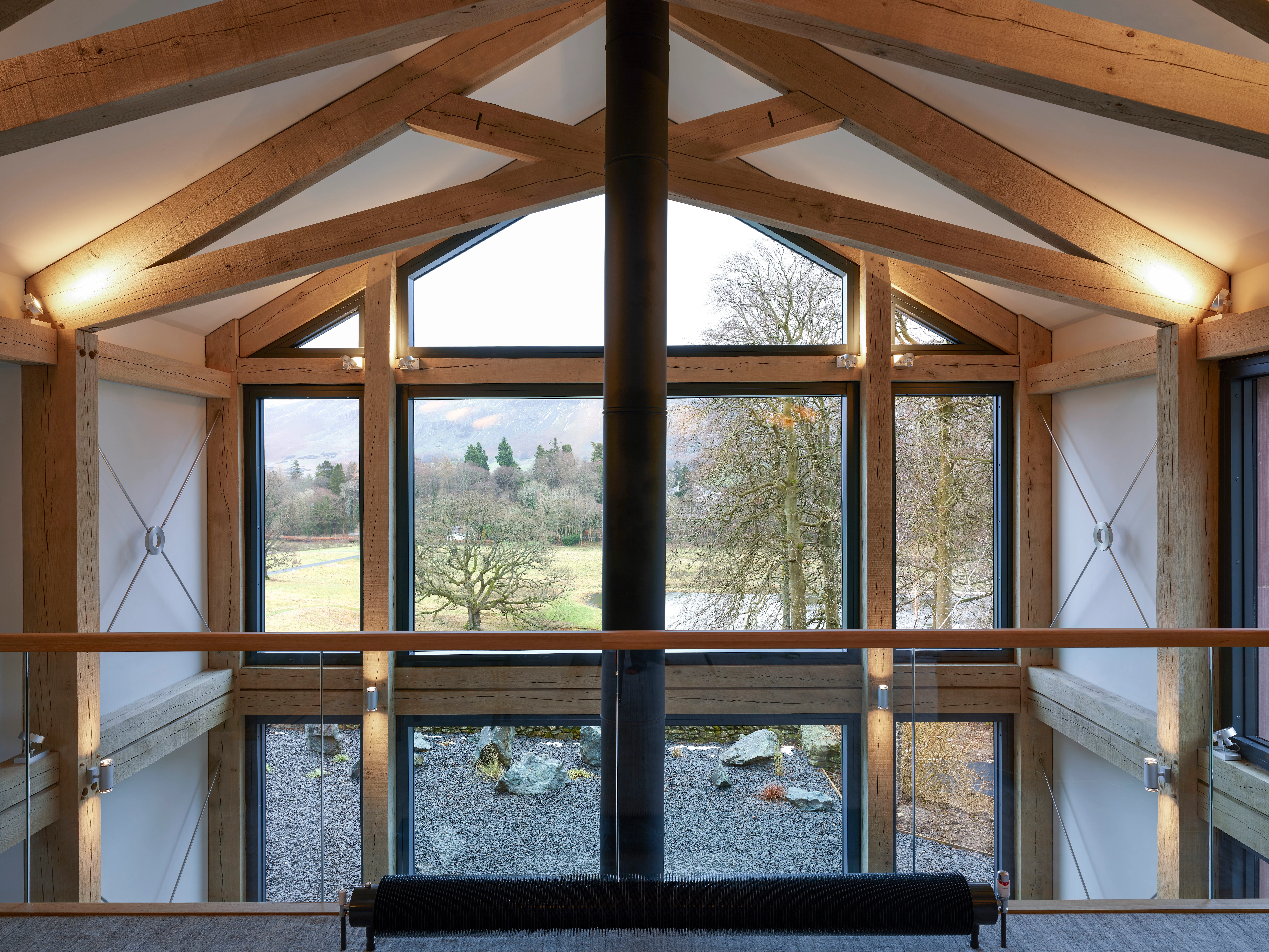 A mezzanine sitting area with an oak framed scissor truss