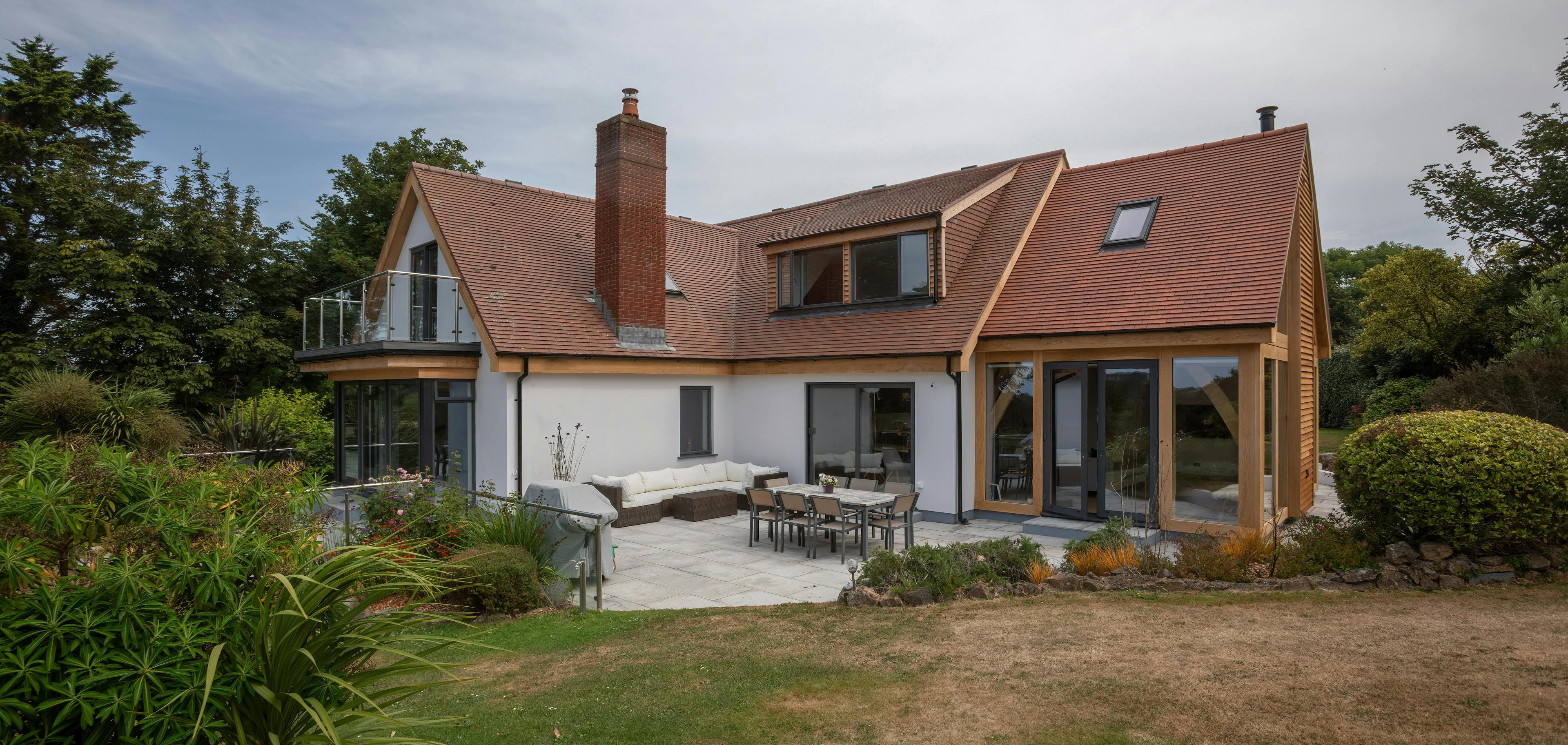 Exterior view of a contemporary bungalow with an oak-framed extension