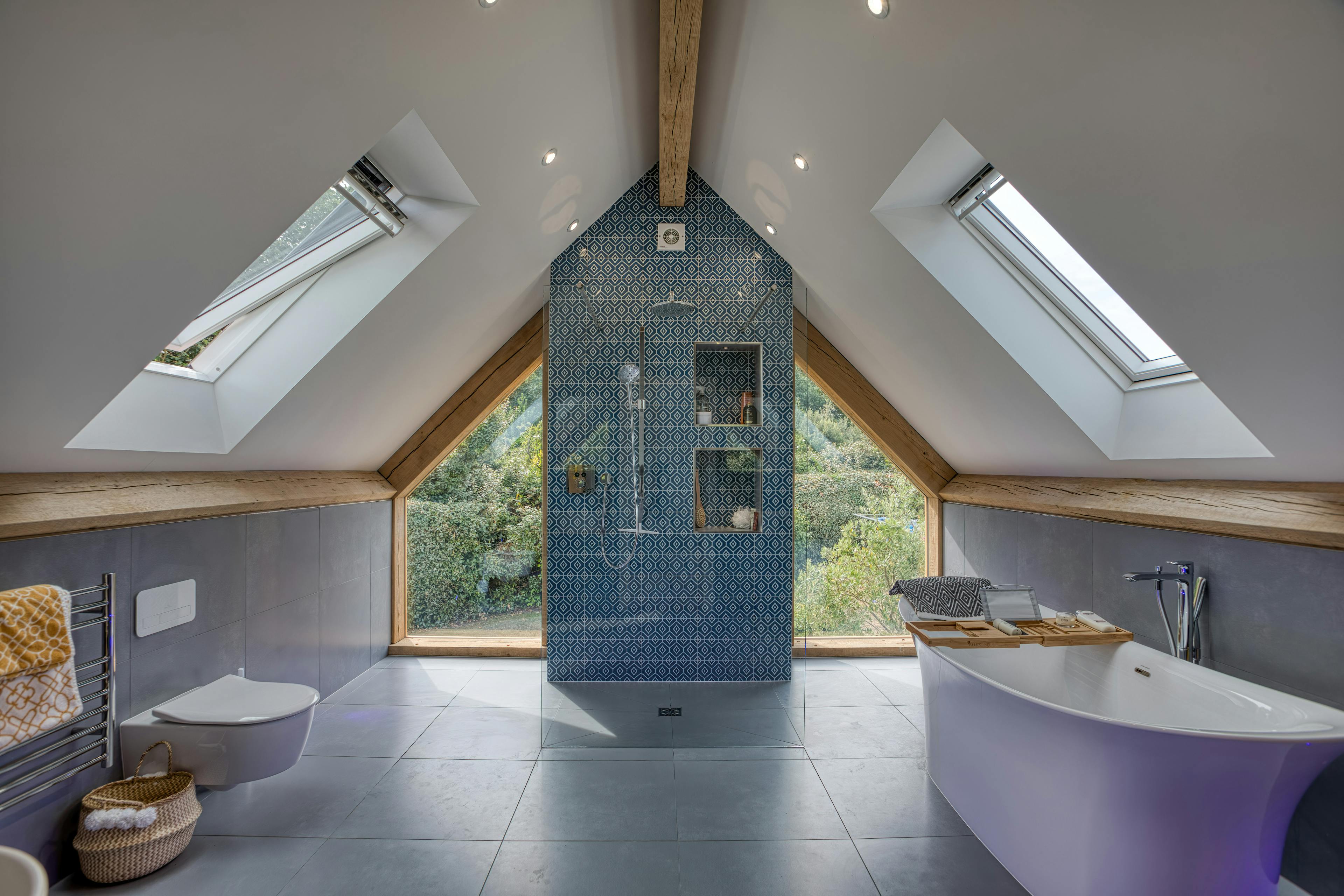 Interior view of a contemporary large bathroom featuring exposed oak-frame beams