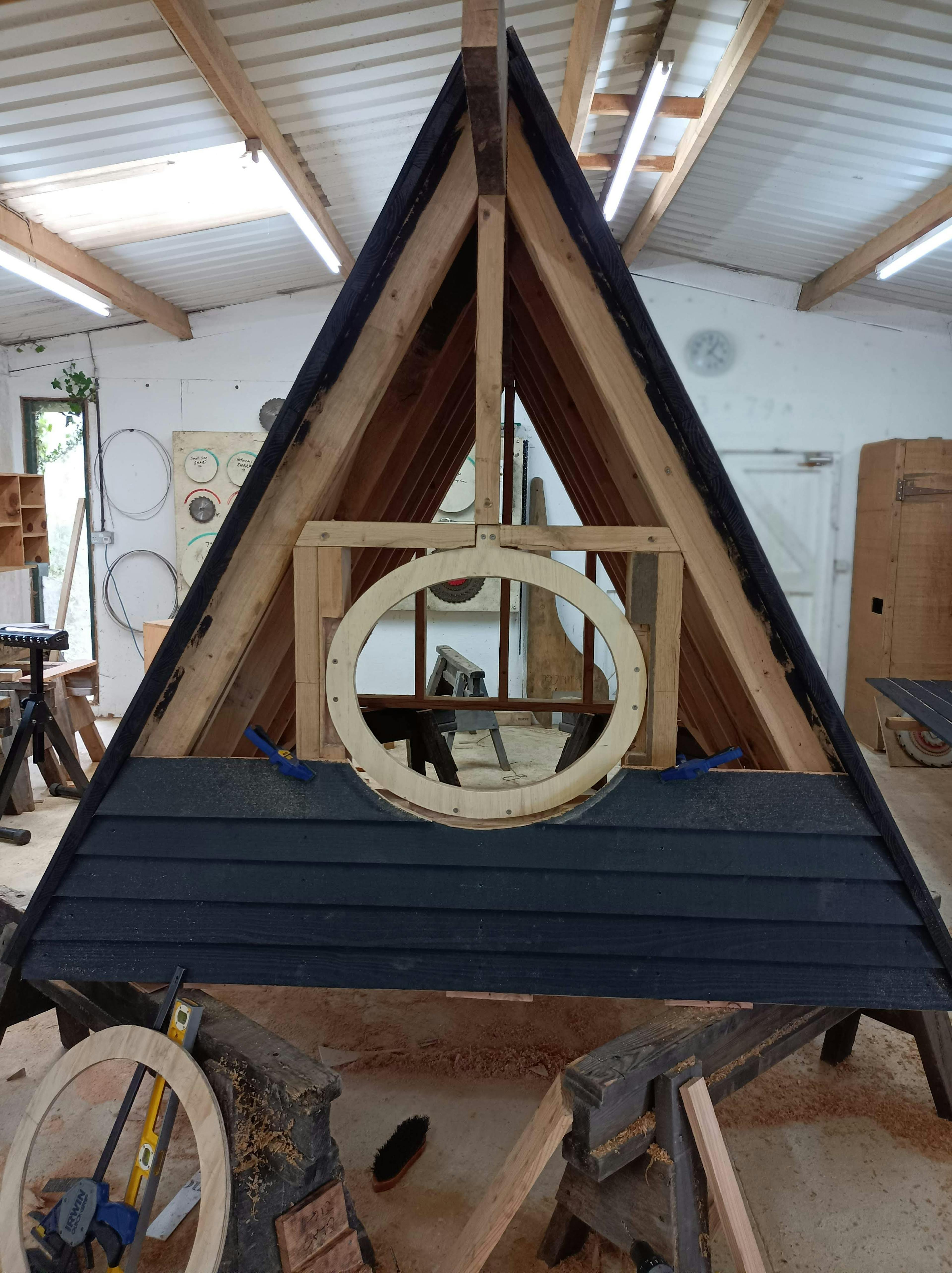 In a workshop an oak framed cabin is constructed