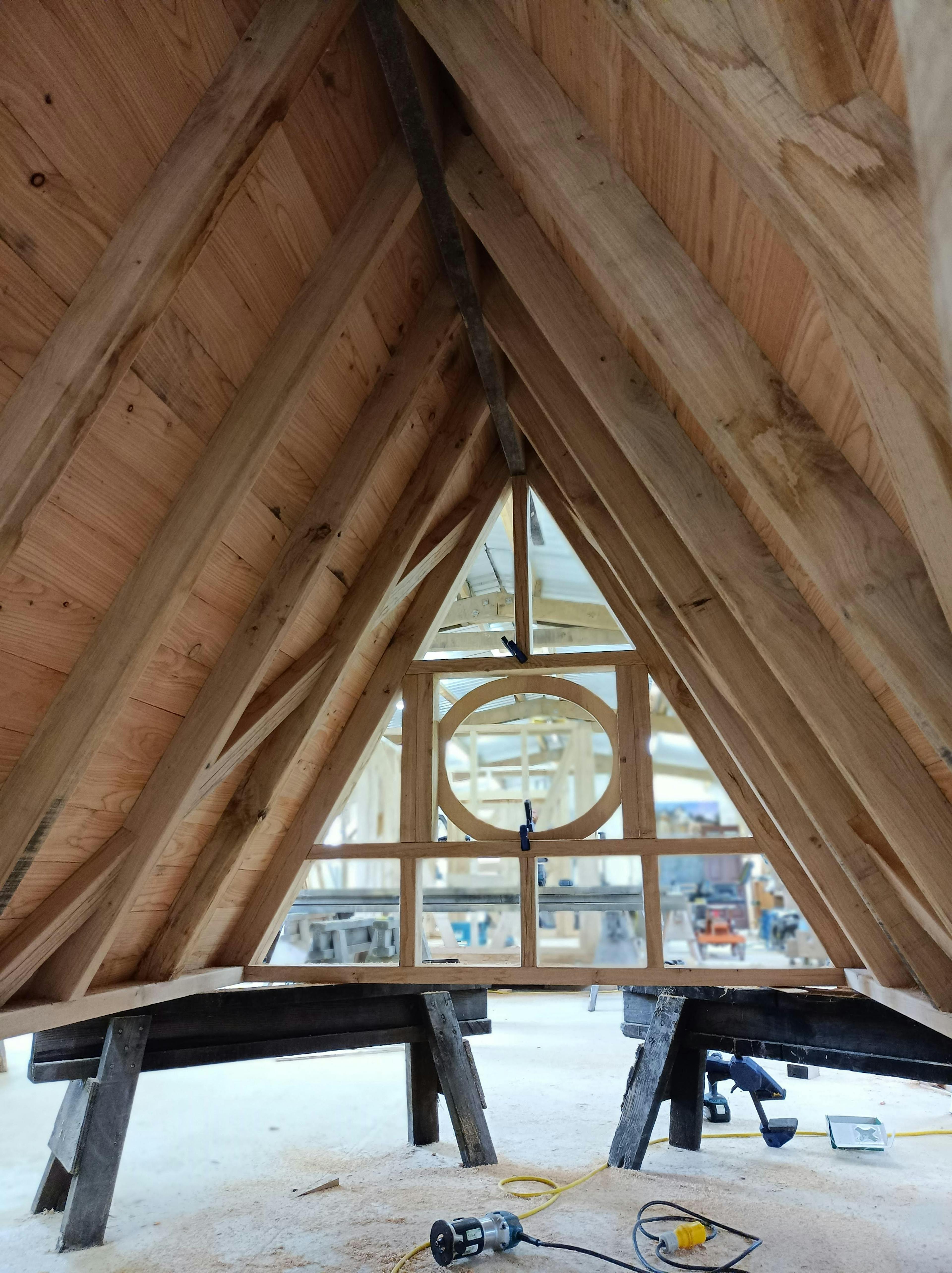 In a workshop an oak framed cabin is constructed