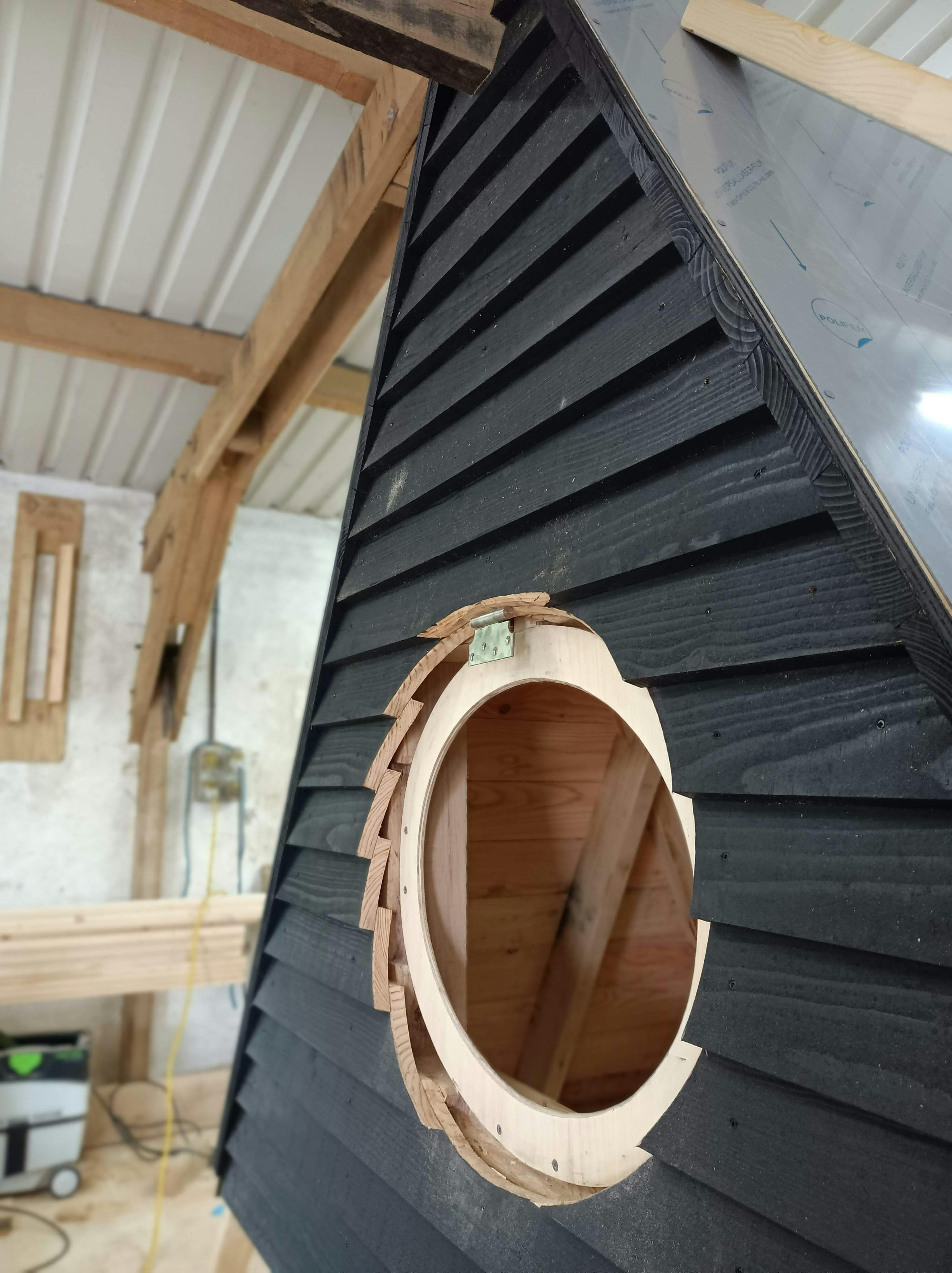 In a workshop an oak framed cabin is constructed