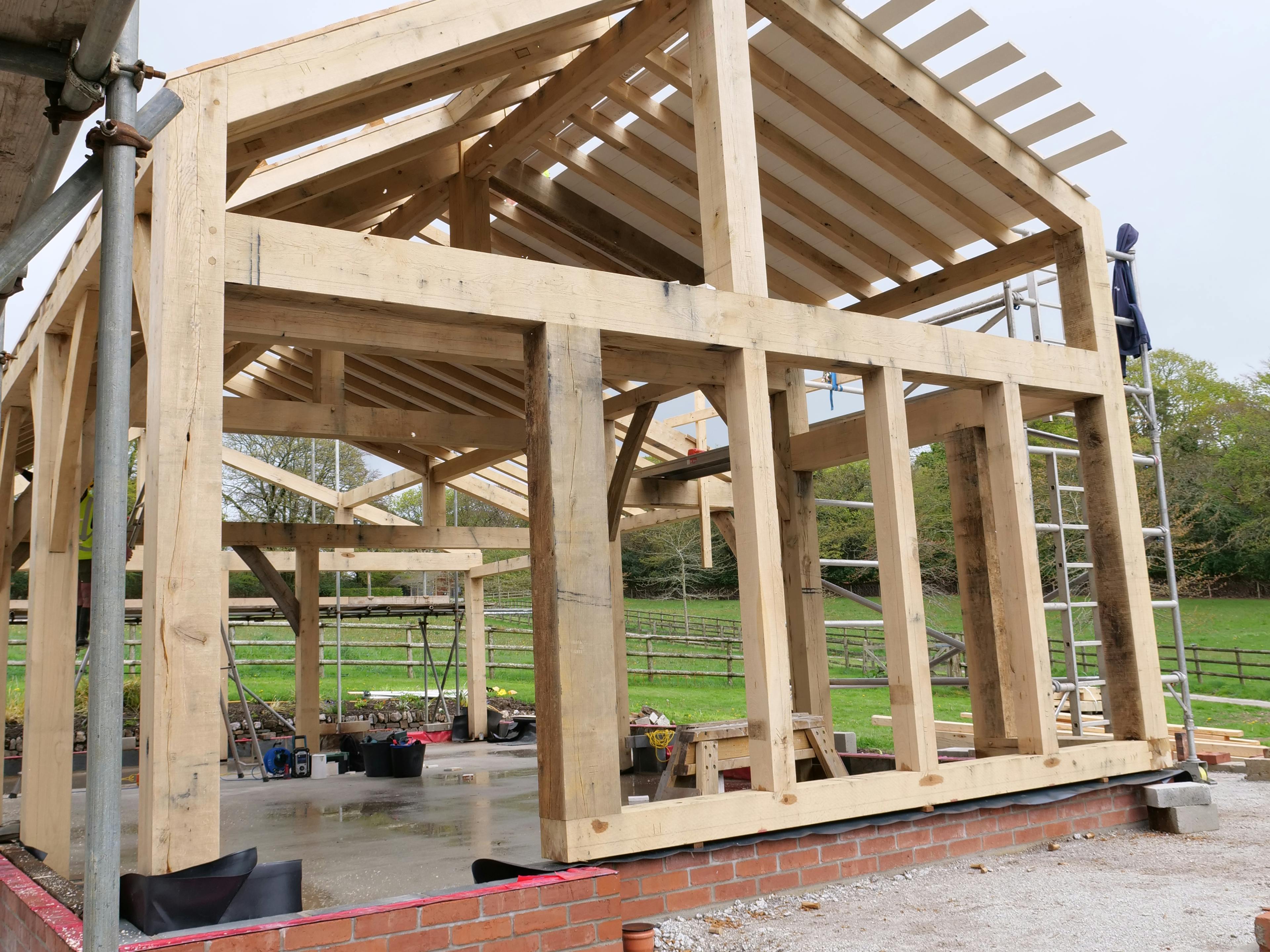 An oak frame being installed on a construction site