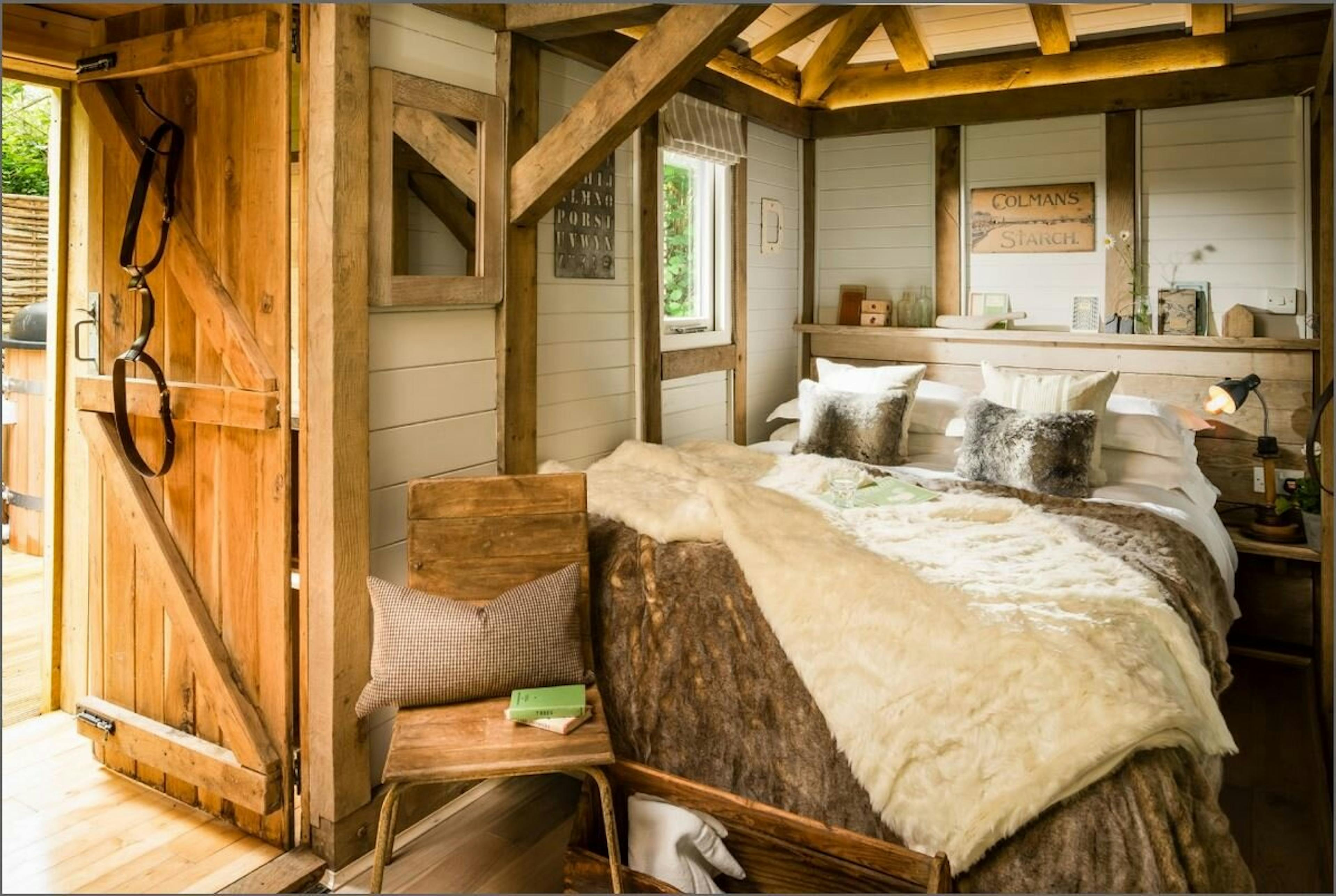 The bedroom area of an open plan oak framed cabin