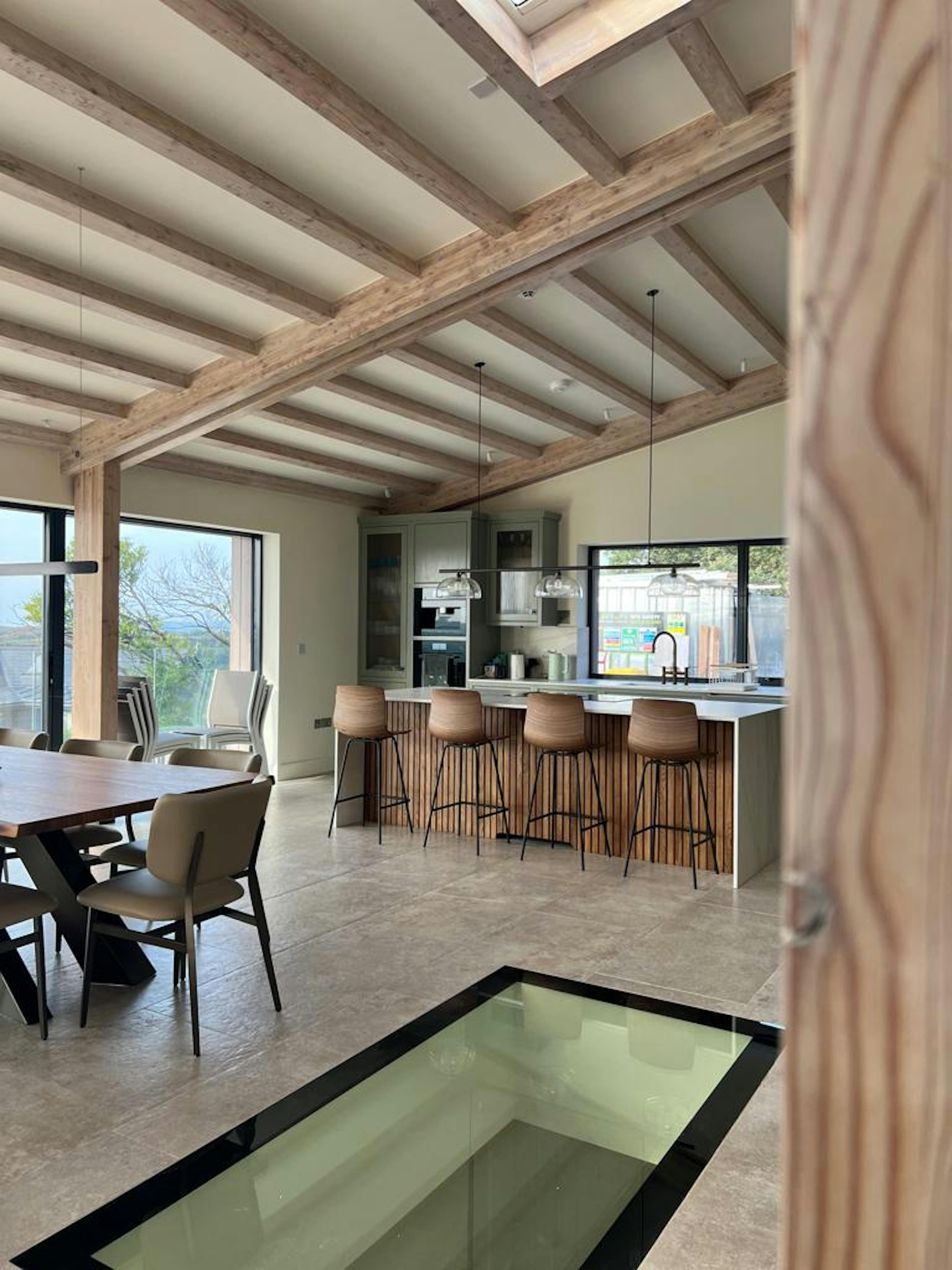 An oak glulam open plan living room with dining and kitchen area