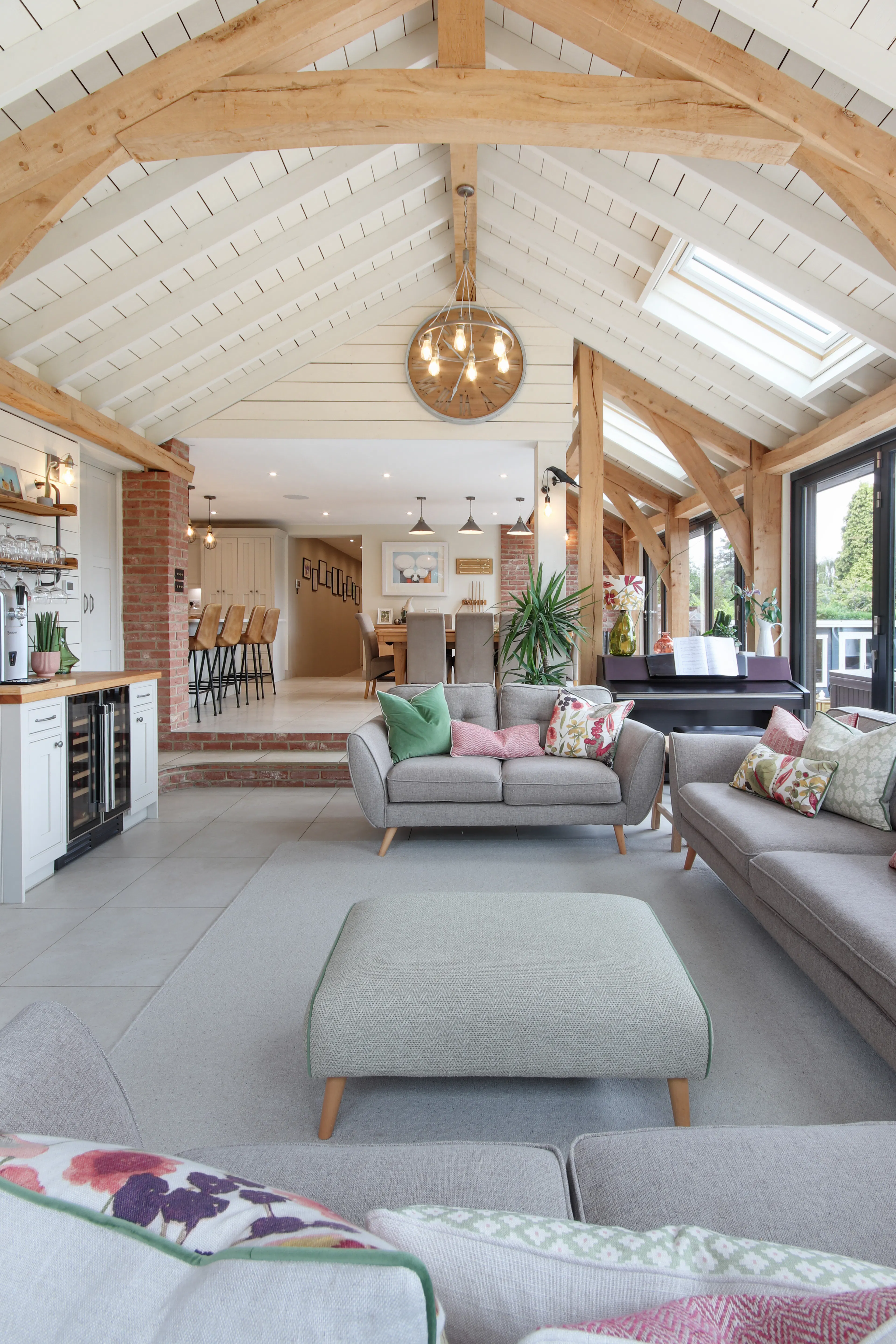 A modern oak framed extension encompassing an open plan family room and dining area with integrated glazing and roof lights providing lots of natural light.