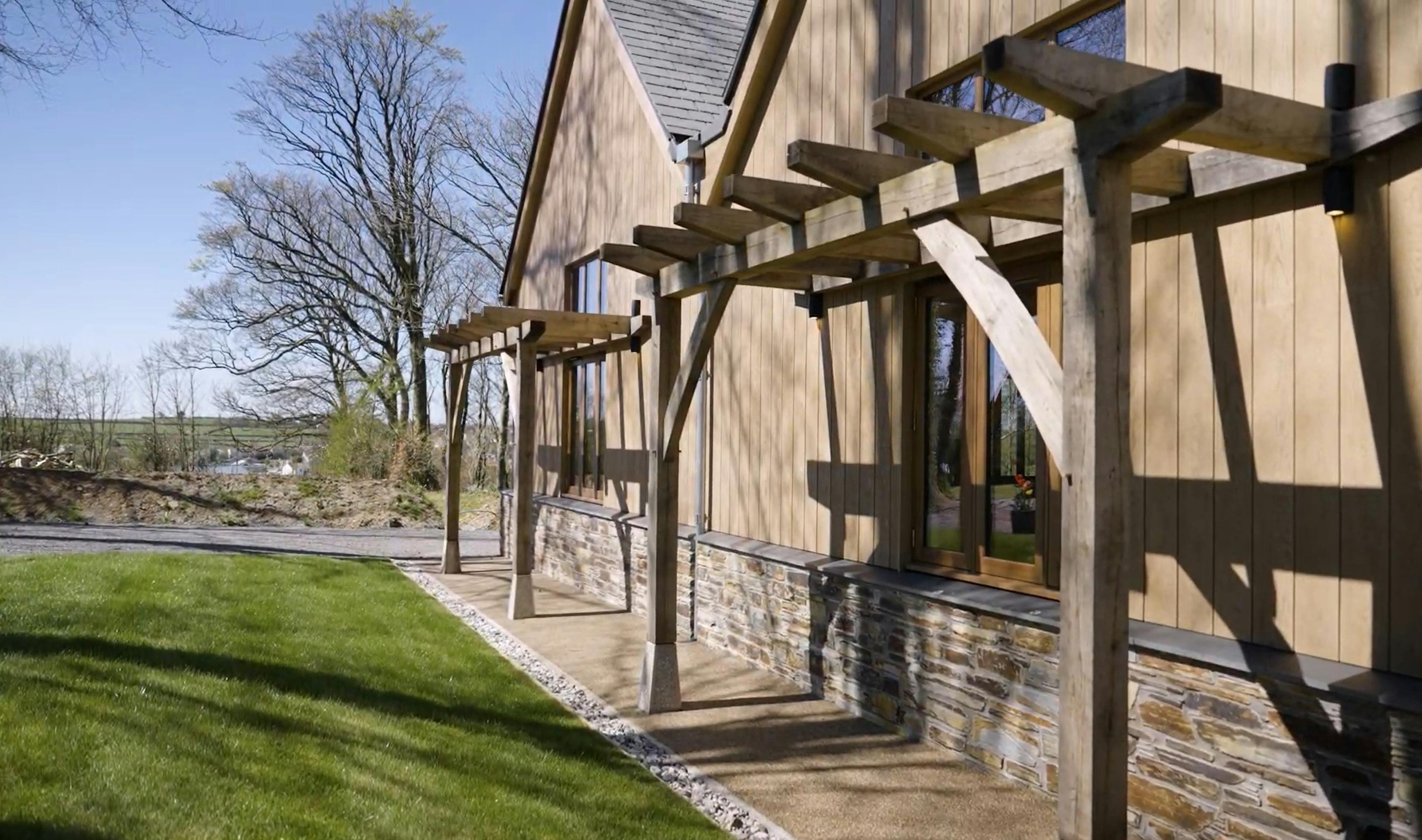 An oak frame trellis on the front of an oak frame wedding barn