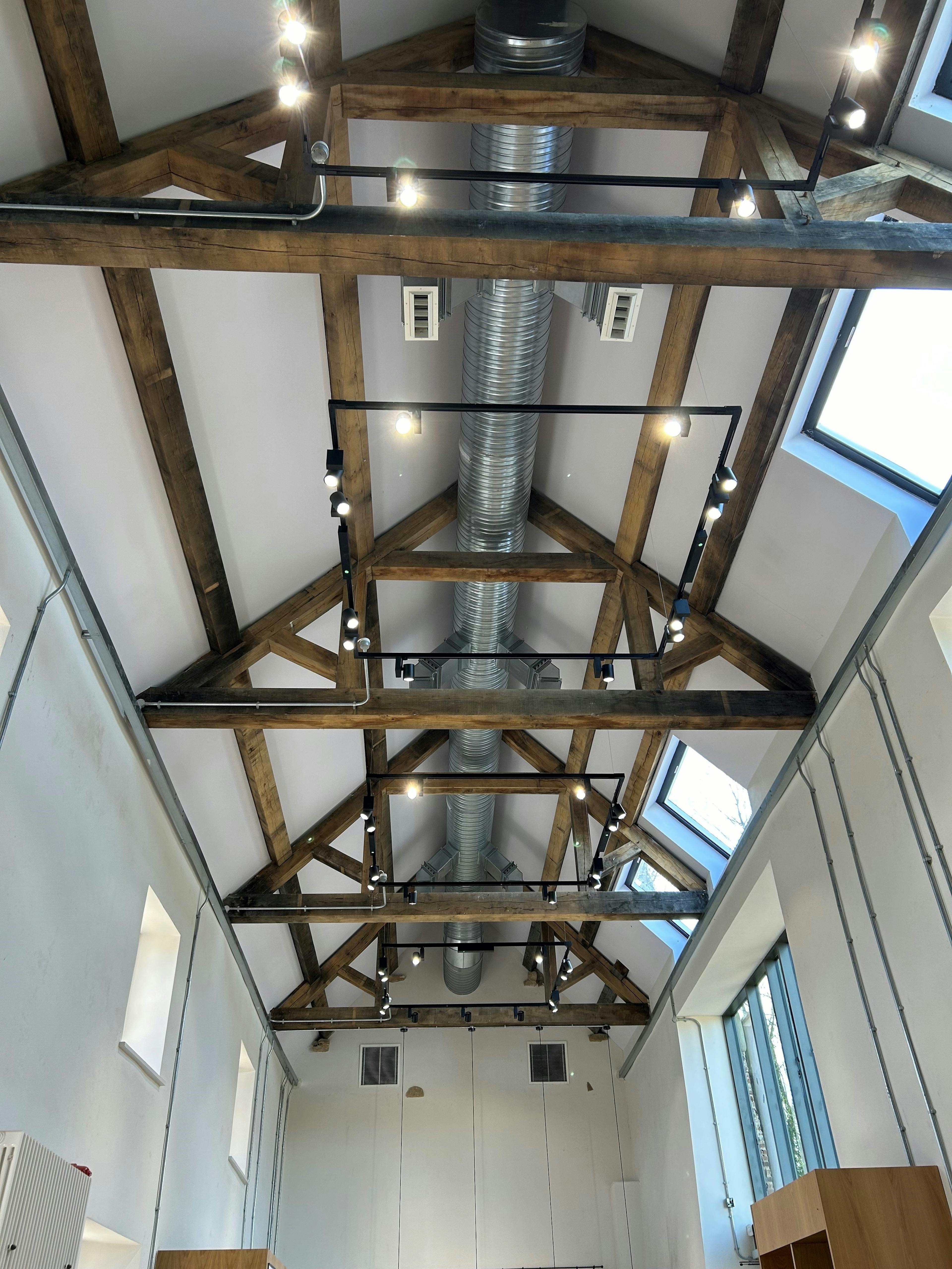 Oak trusses in a renovated coach house to create a new cafe for visitors to Belsay Hall