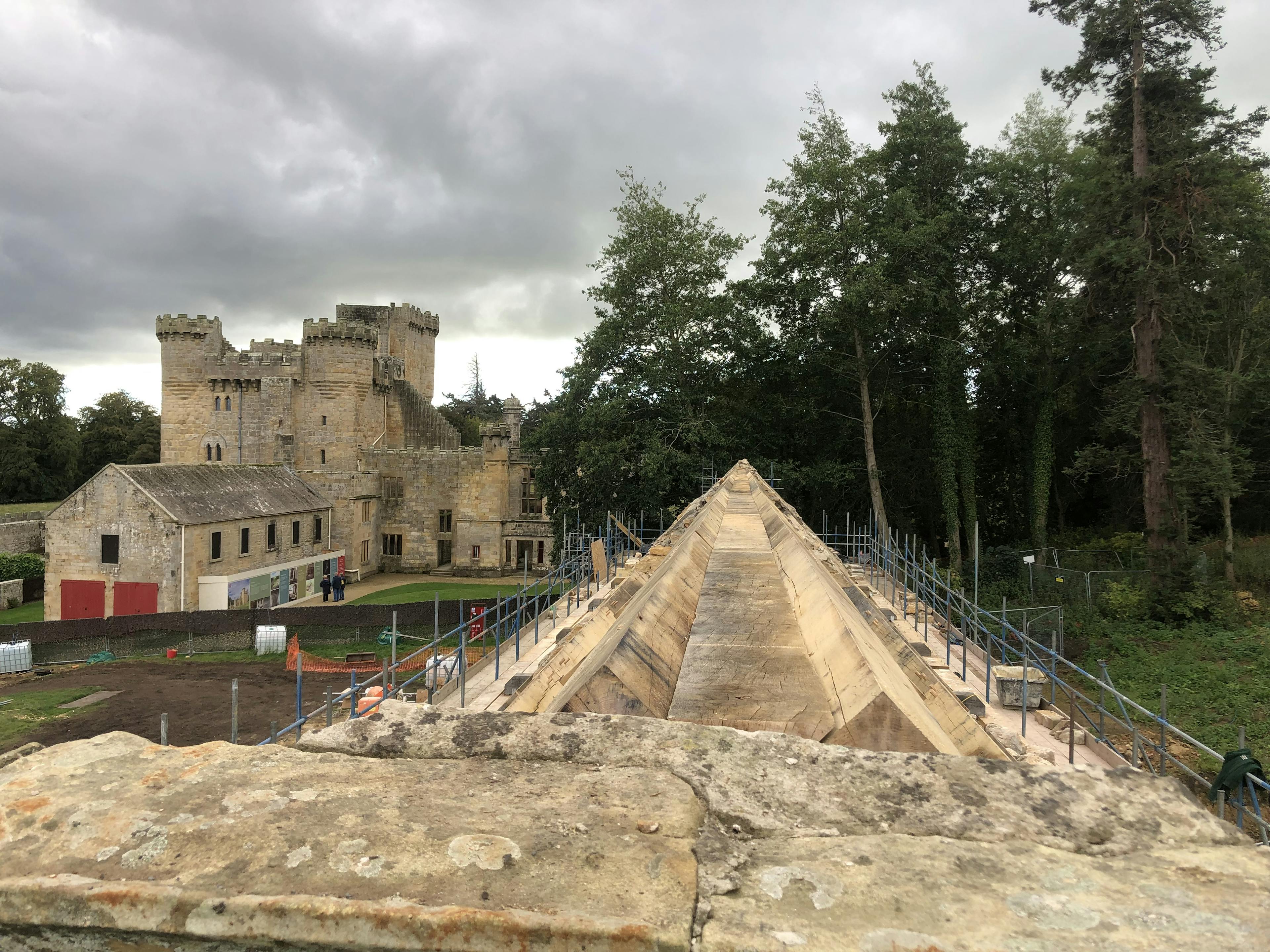 Oak trusses being installed in a renovated coach house to create a new cafe for visitors to Belsay Hall