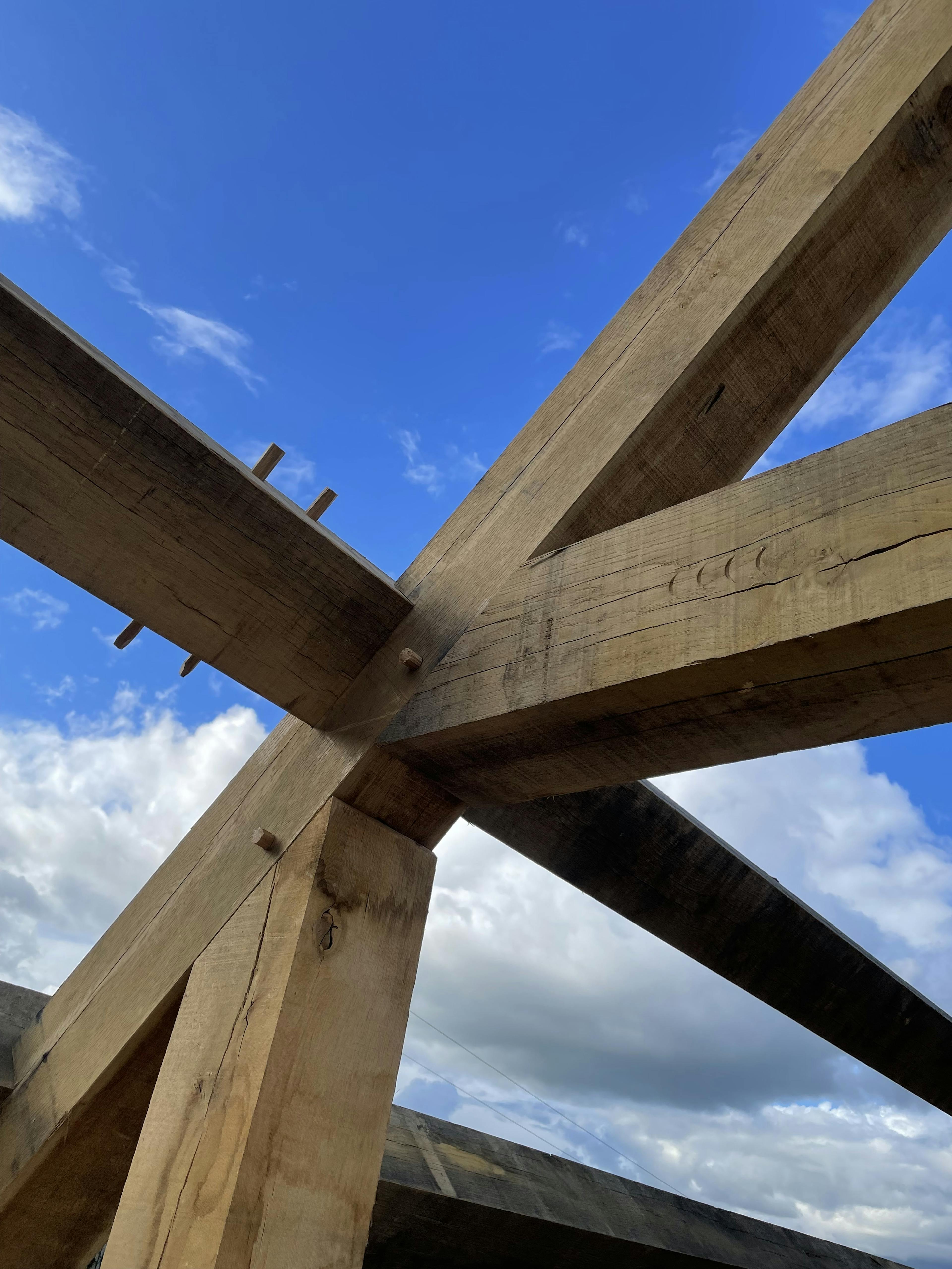A close up image of an oak frame being installed showing carpenters marks