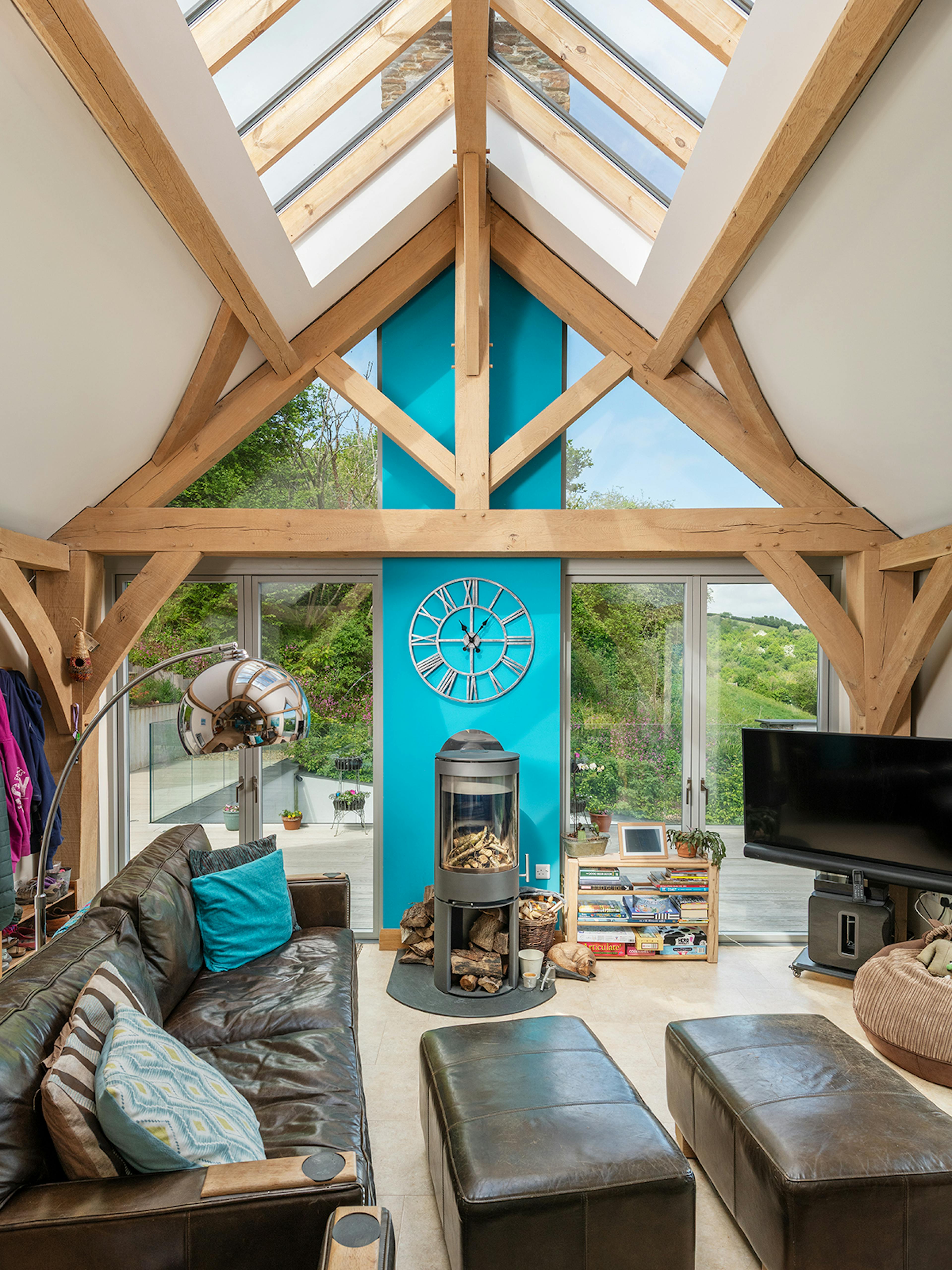 A vaulted ceiling in an oak framed living room with rooflights