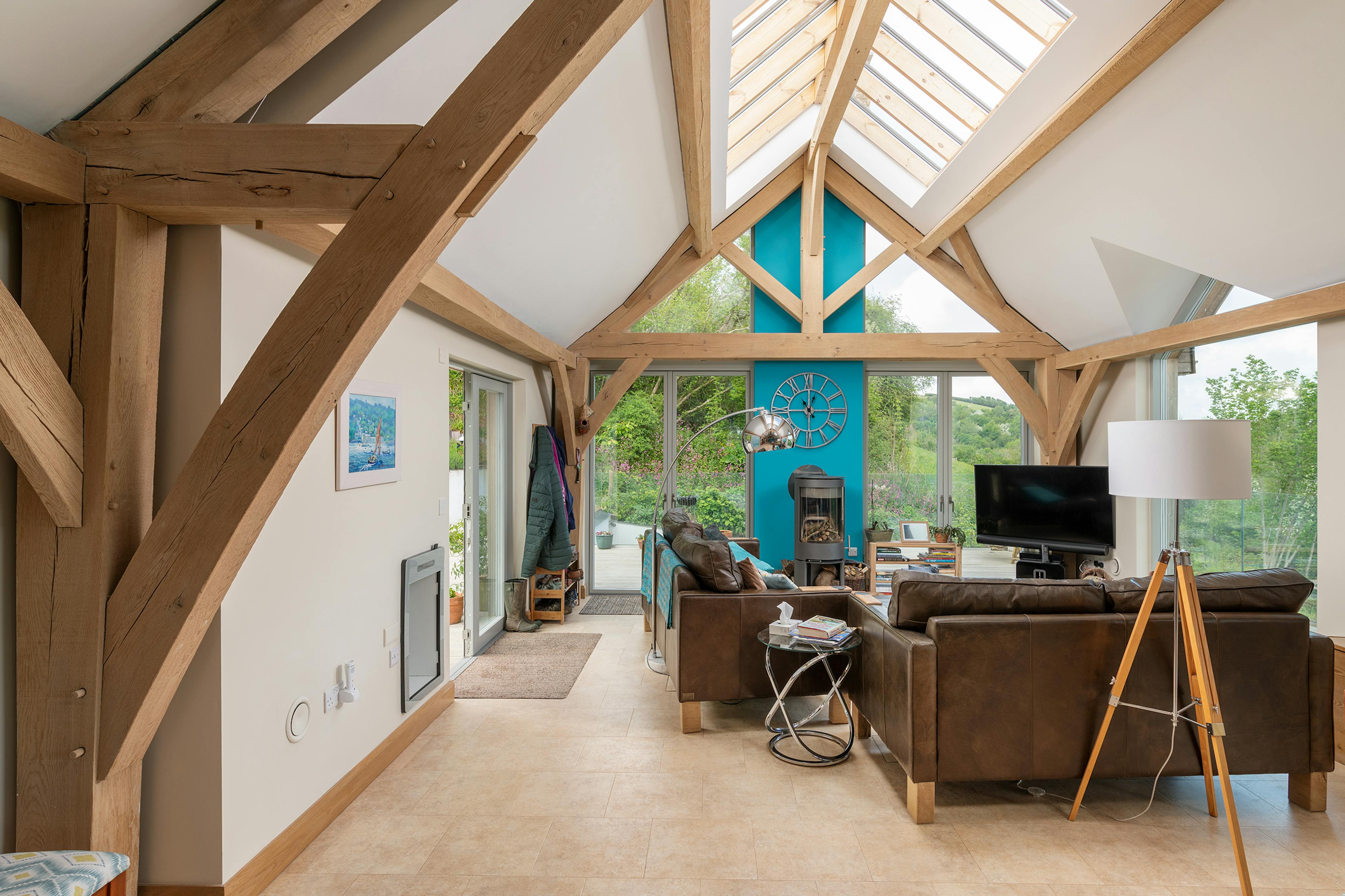 A vaulted ceiling in an oak framed living room with rooflights