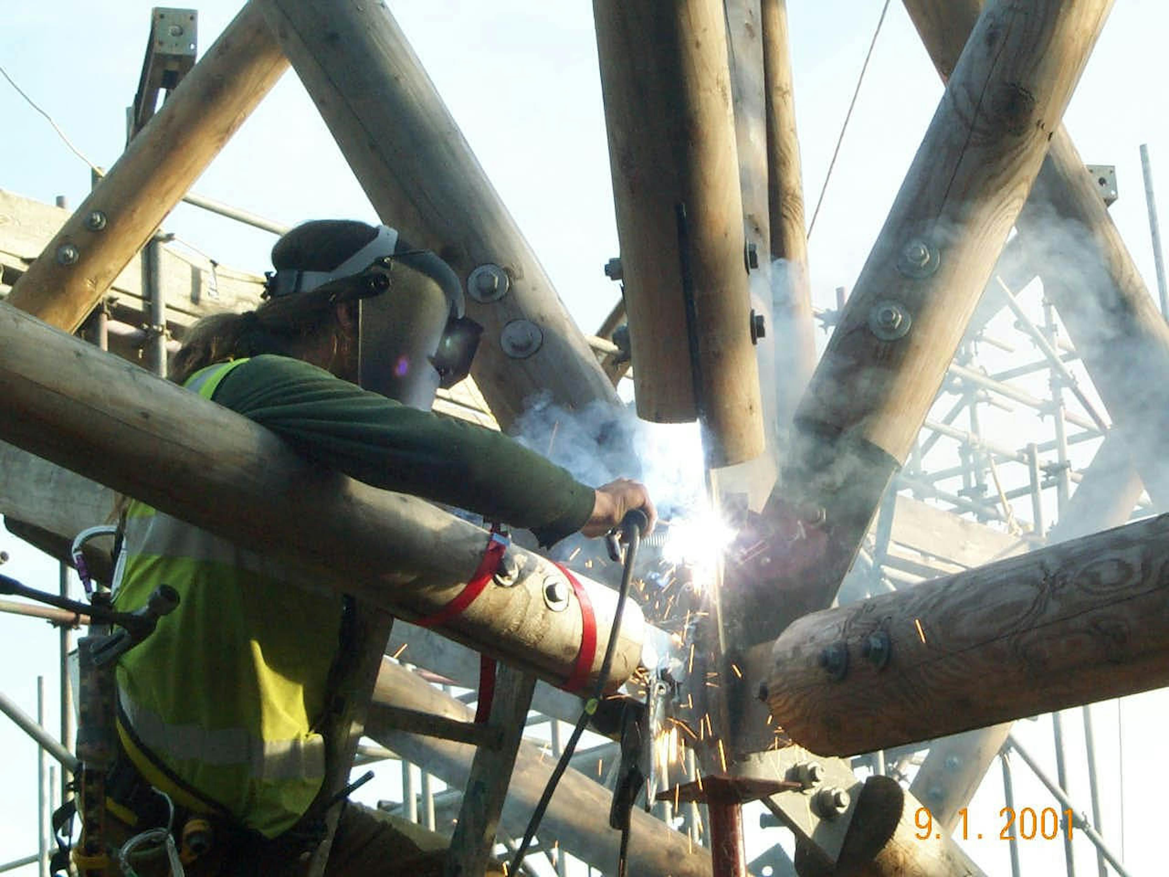 Worker welding metal components of the solar canopy at the Earth Centre site in Doncaster