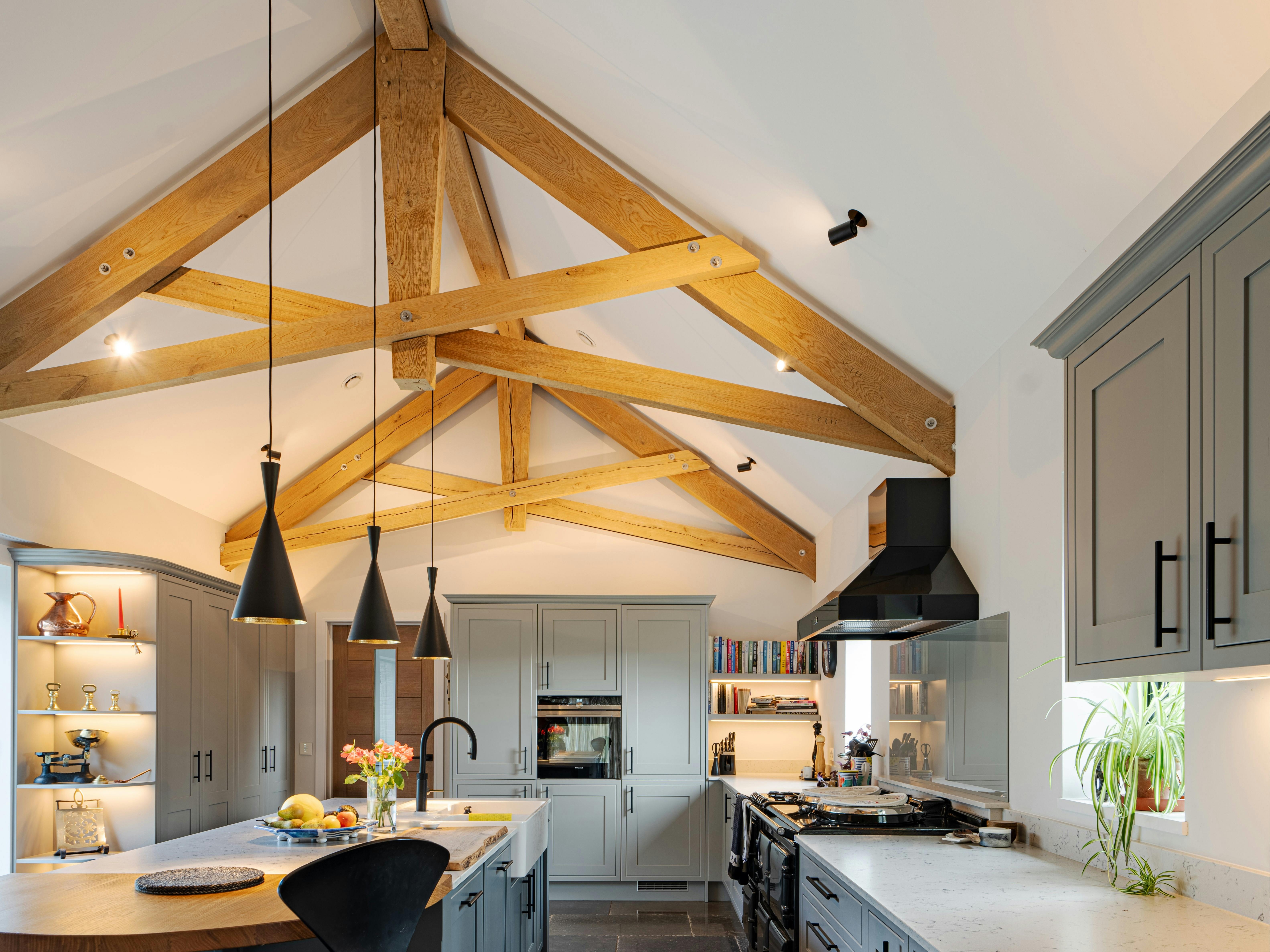 A modern oak framed kitchen with a central island and scissor truss