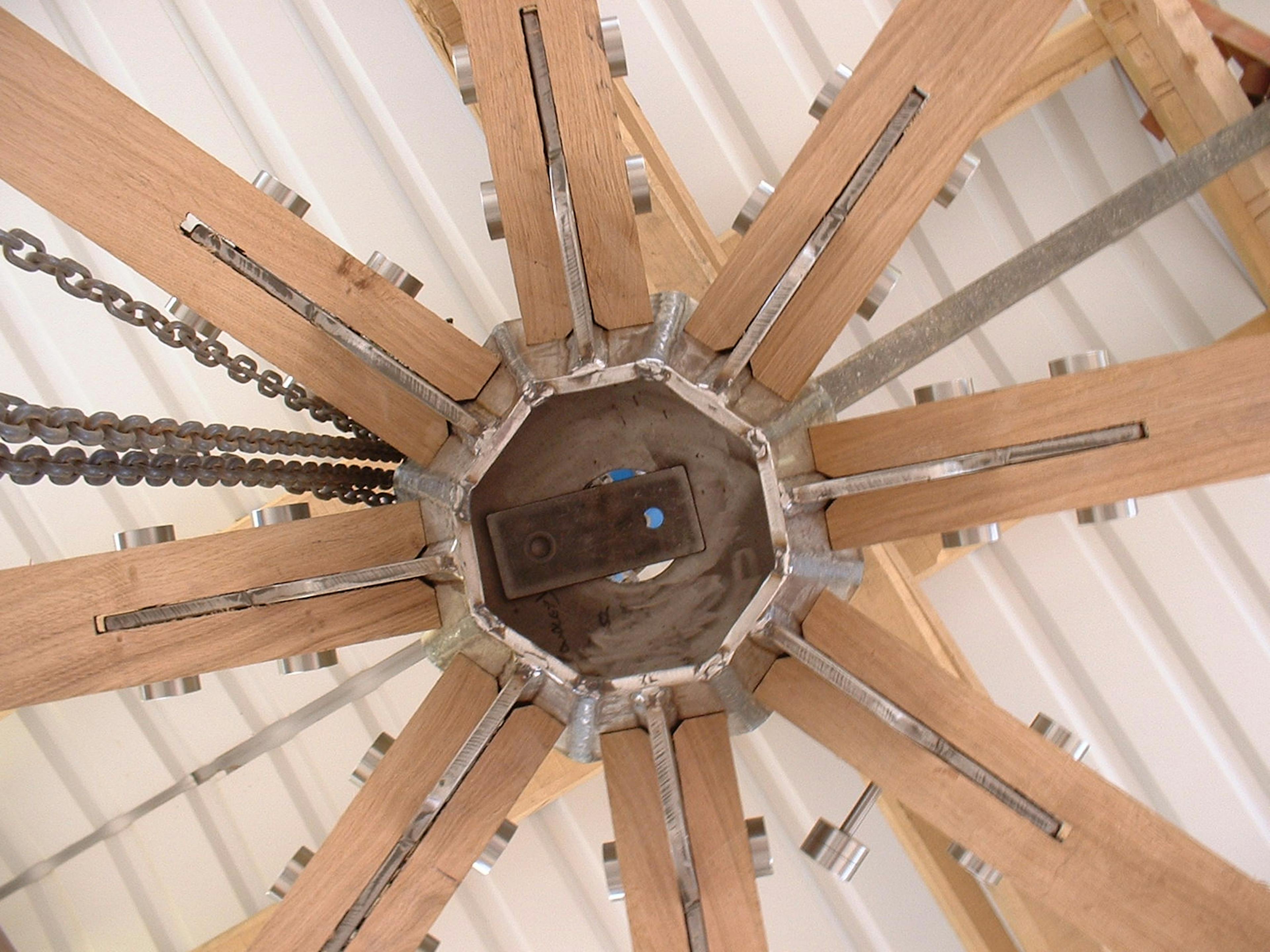 Close-up of timber roof structure detail in a workshop, highlighting precise joinery and craftsmanship of the wooden beams