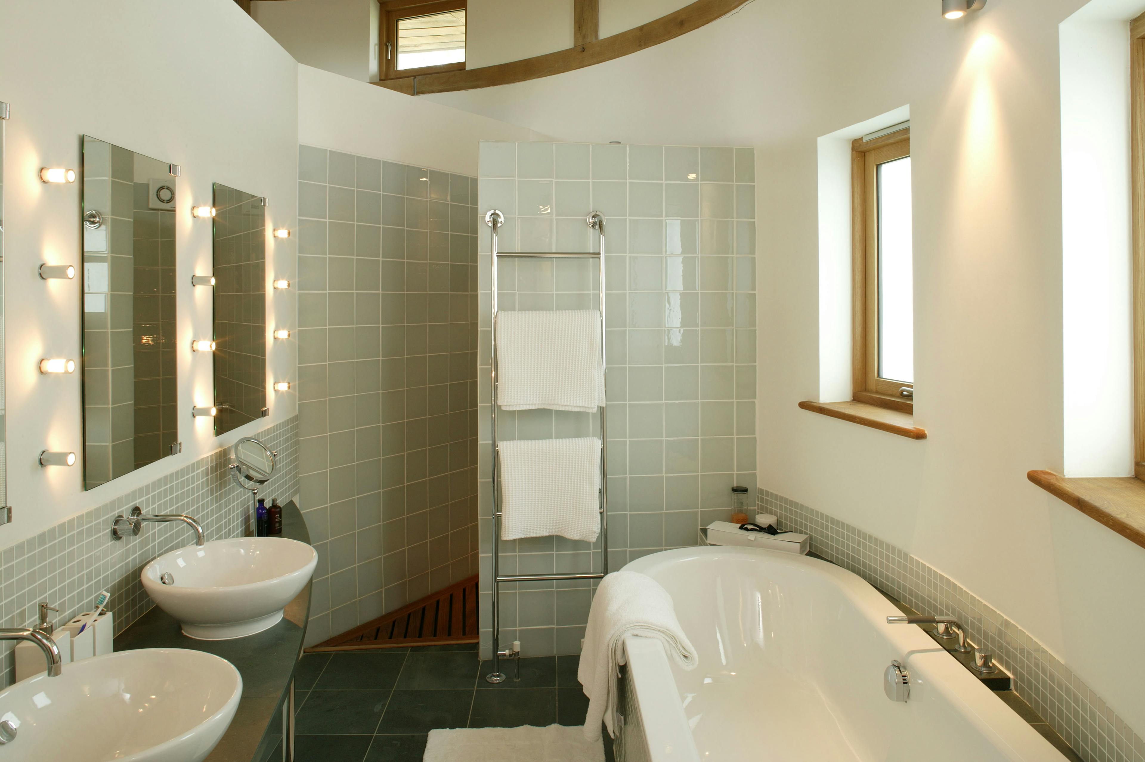 Finished interior of a bathroom in an oak-framed house, featuring natural wood accents, modern fixtures, and a warm, inviting design