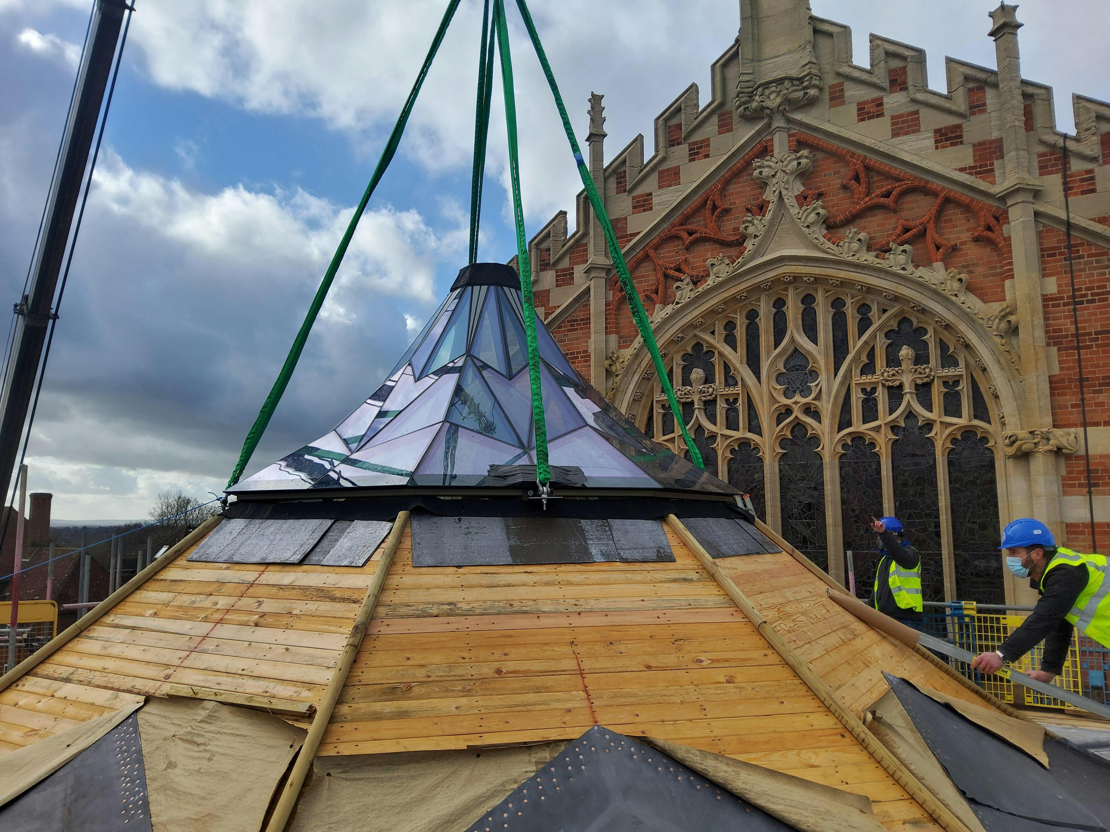 Construction of a glazed timber structure at Radley College, featuring exposed oak framing integrated with large glass panels, designed by Purcell Architects