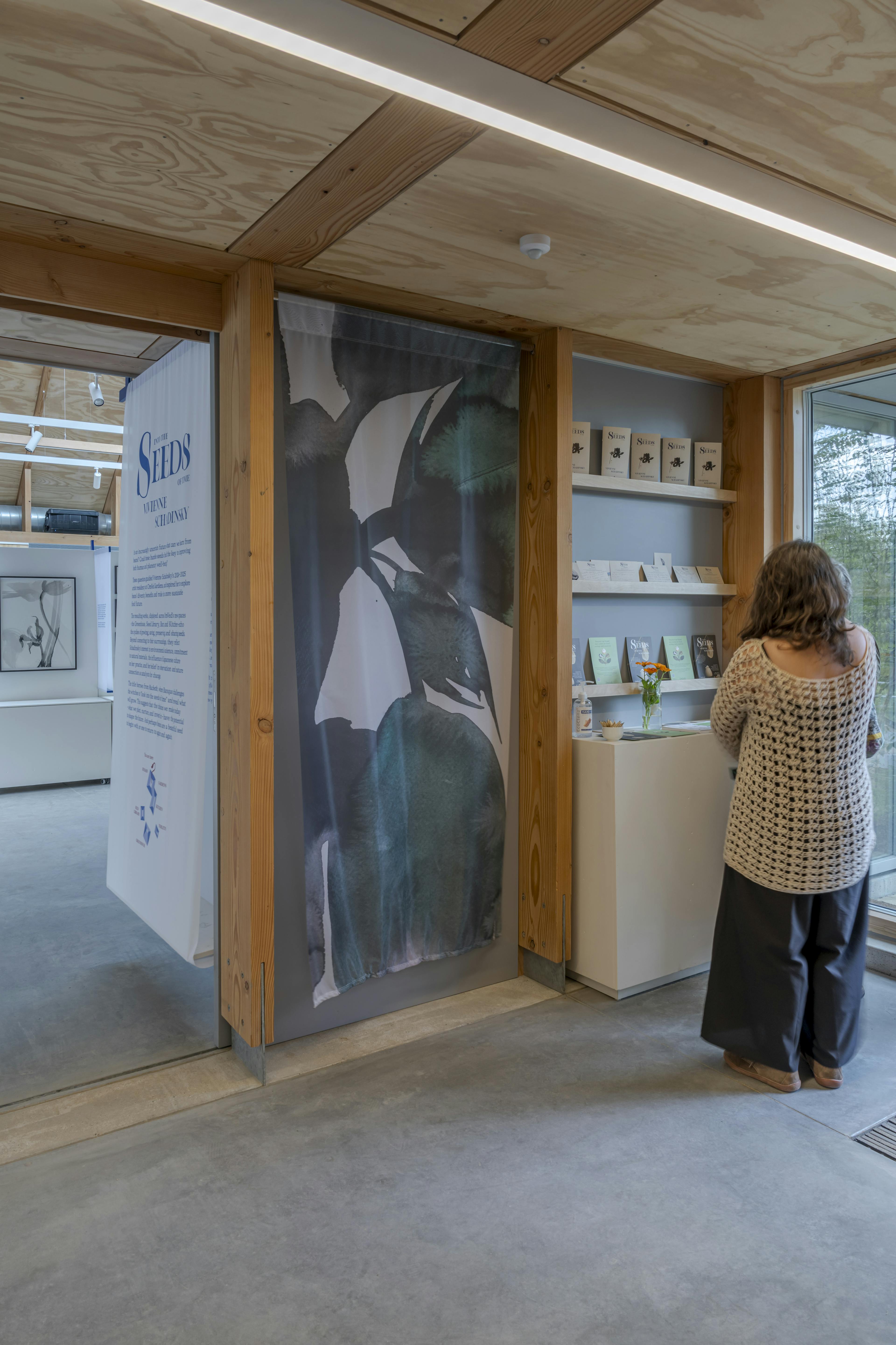 Spacious interior of a Douglas fir-framed event venue with vaulted glazed ceiling and open-plan layout, designed for seminars and exhibitions
