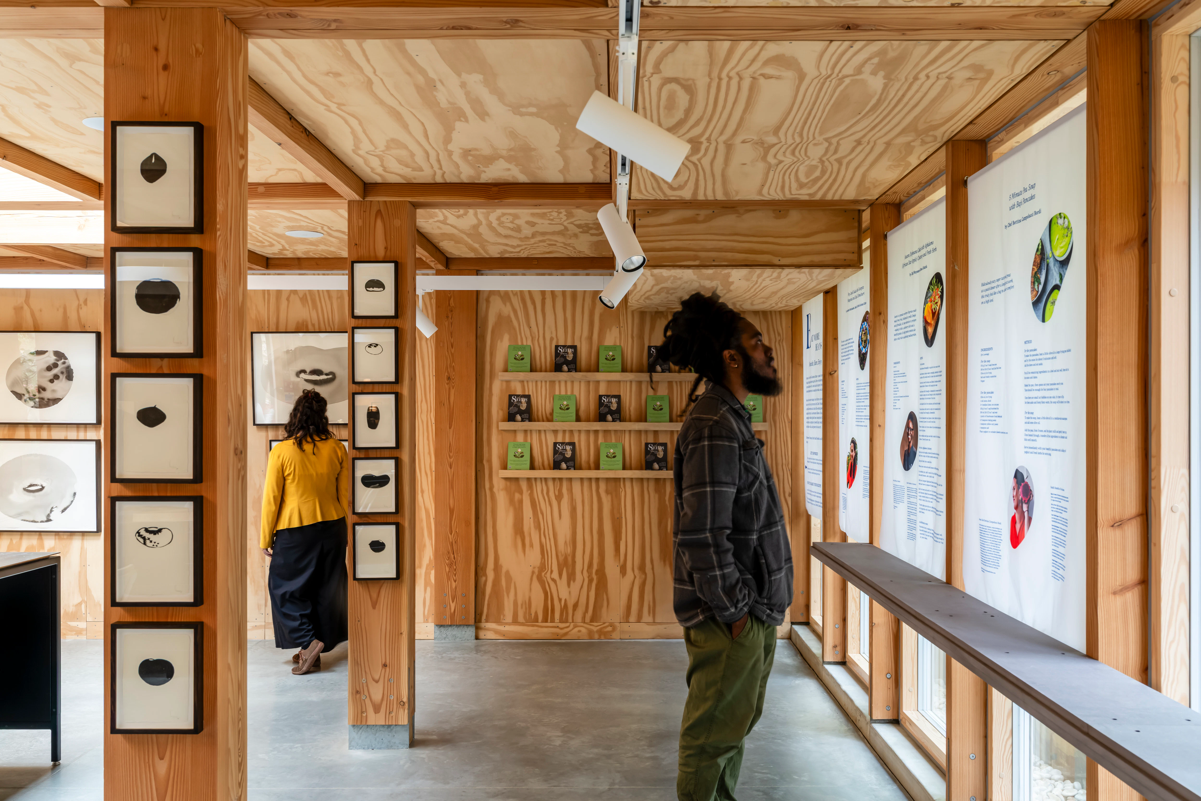 Interior view of an event space featuring exposed Douglas fir timber framing and natural light
