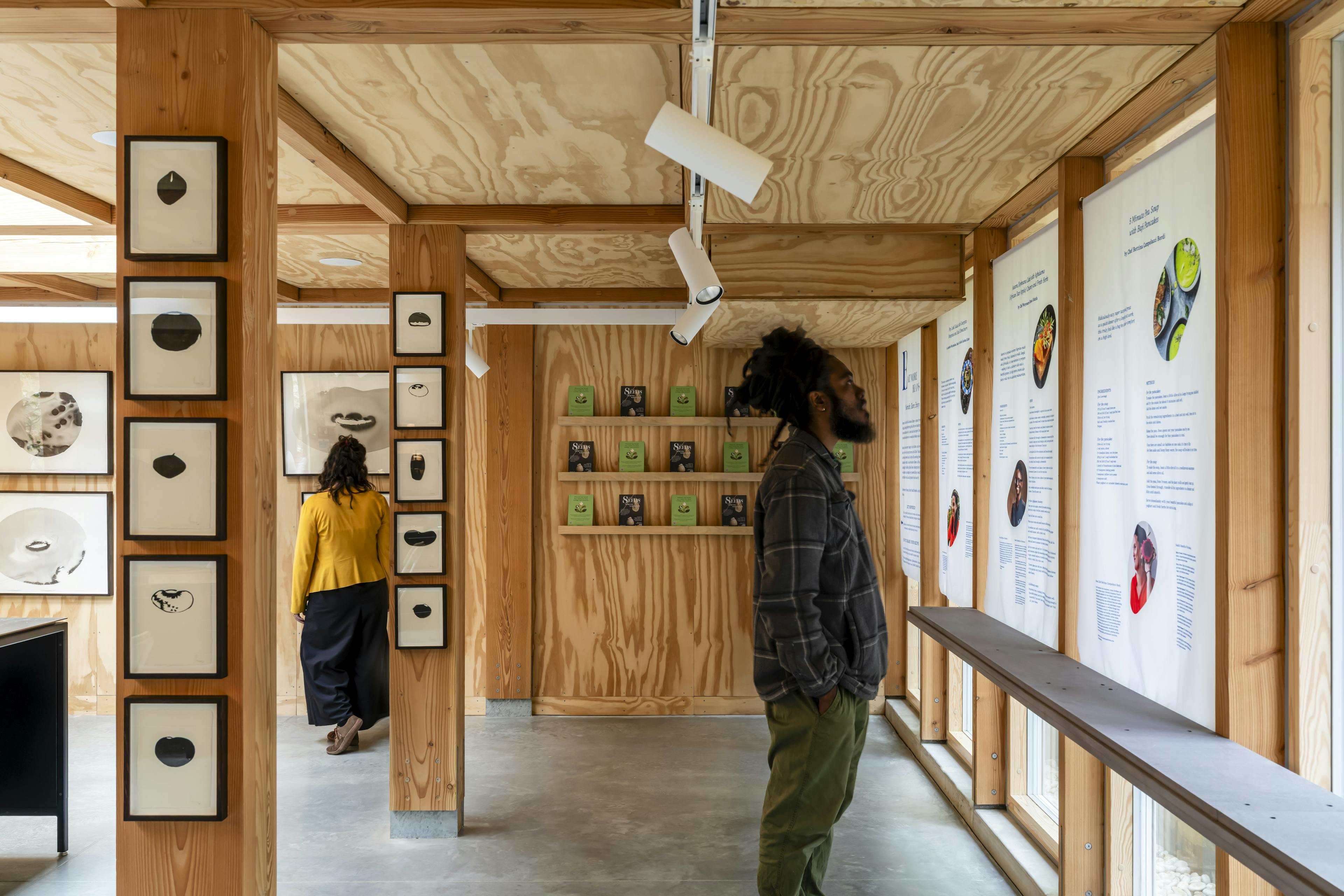 Interior view of an event space featuring exposed Douglas fir timber framing and natural light