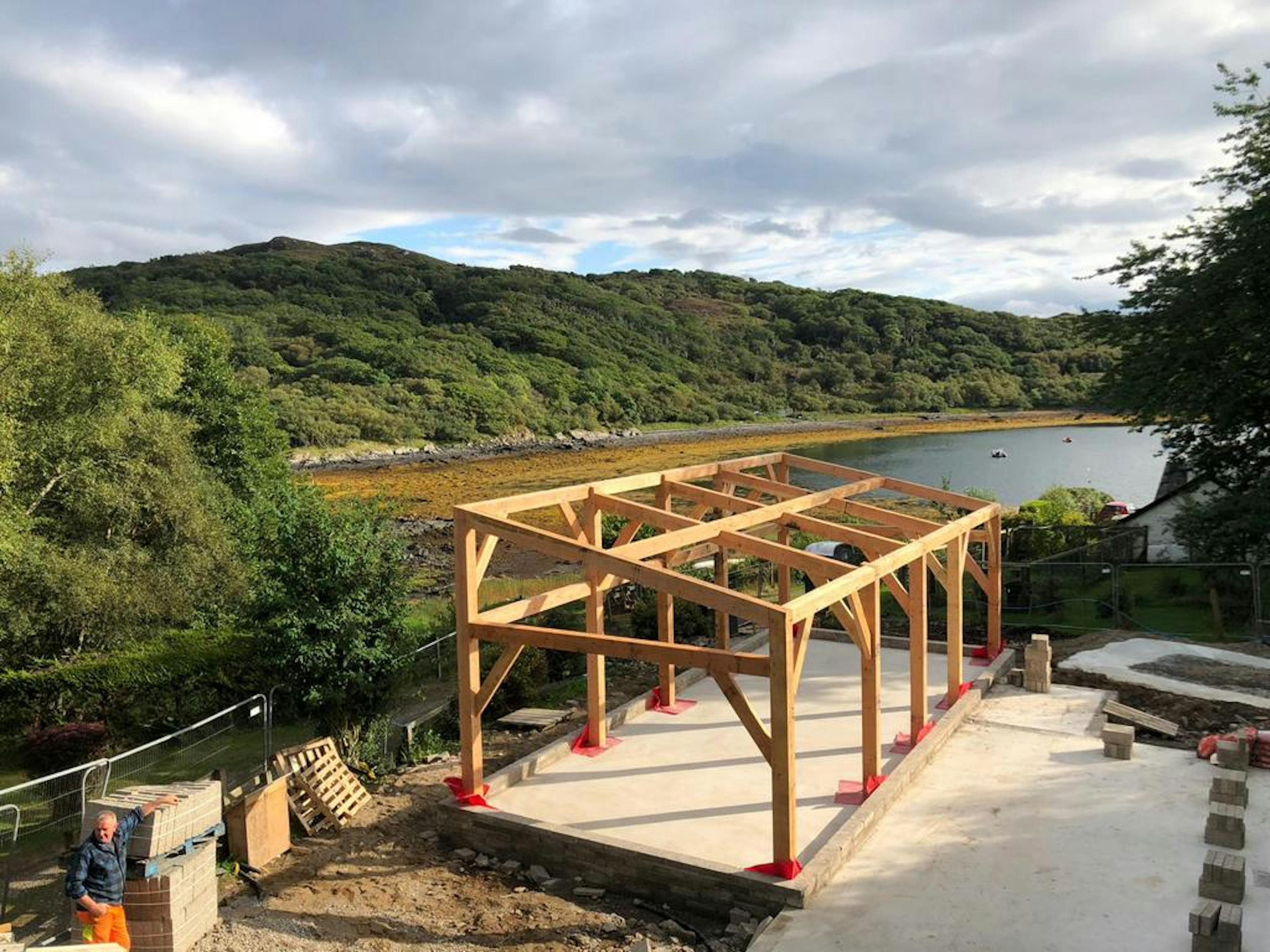 A Douglas fir frame home on the shoreline of a Scottish coast during construction