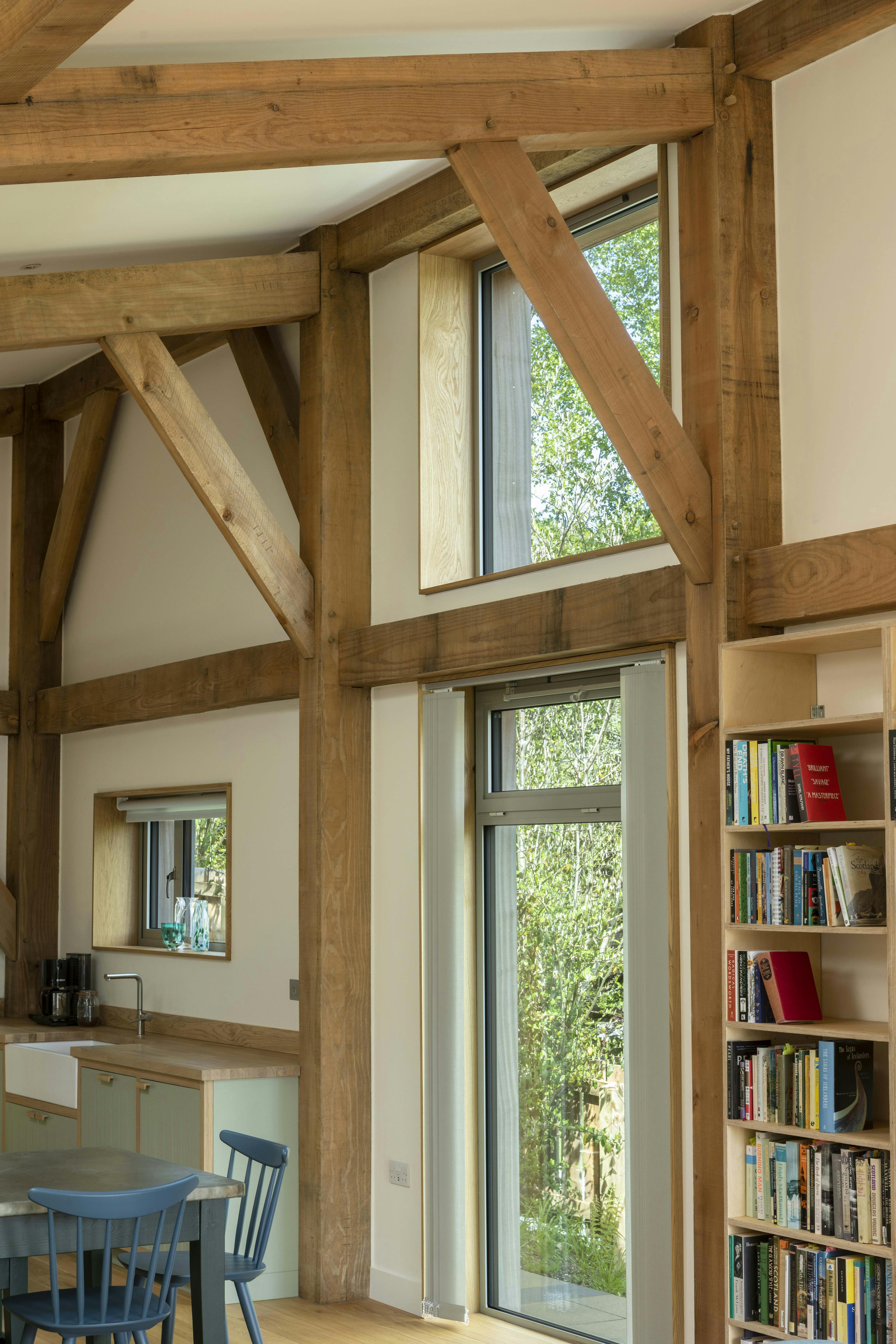 A bookshelf and window framed by a Douglas fir frame