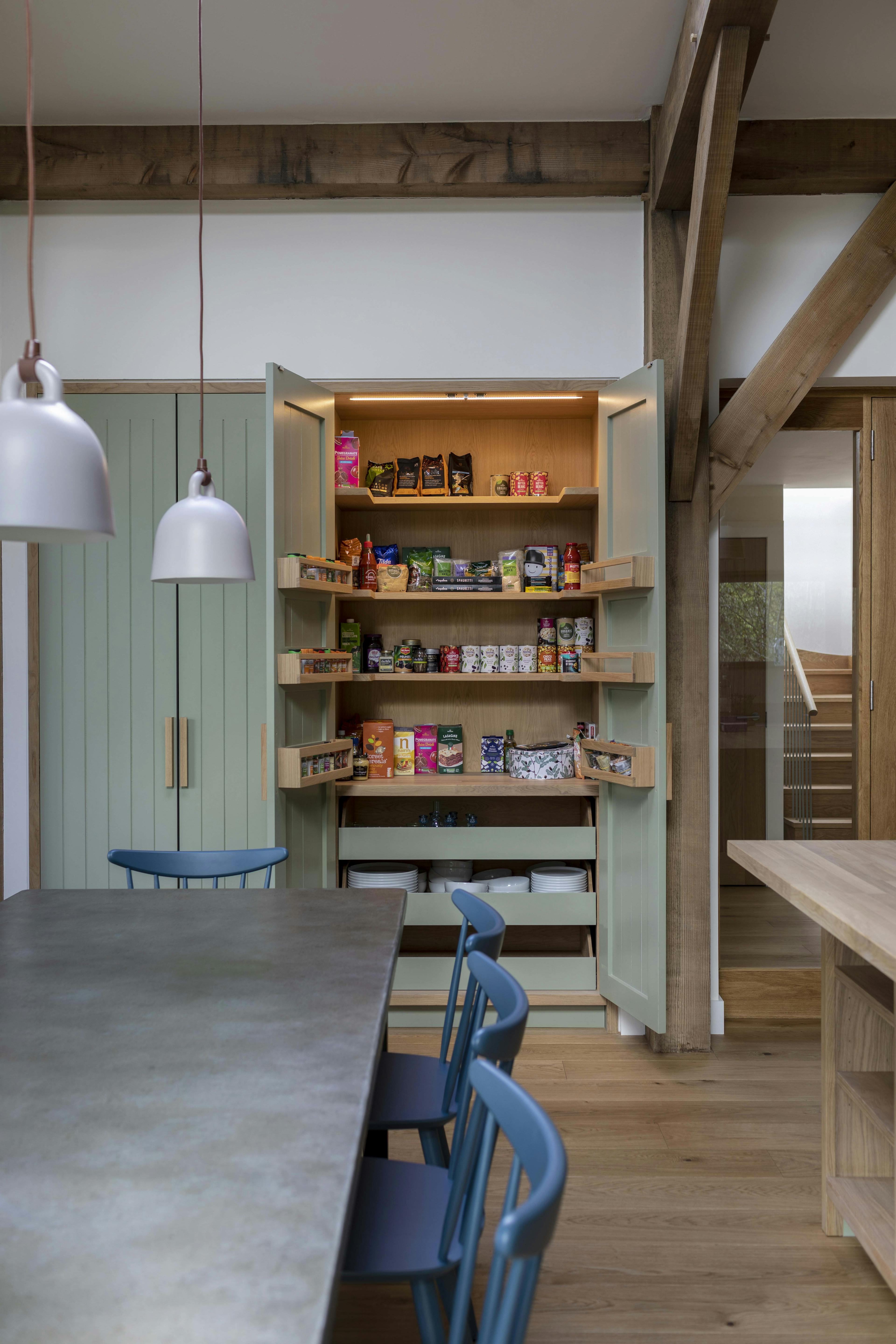 A dining table and larder cupboard under a Douglas fir frame