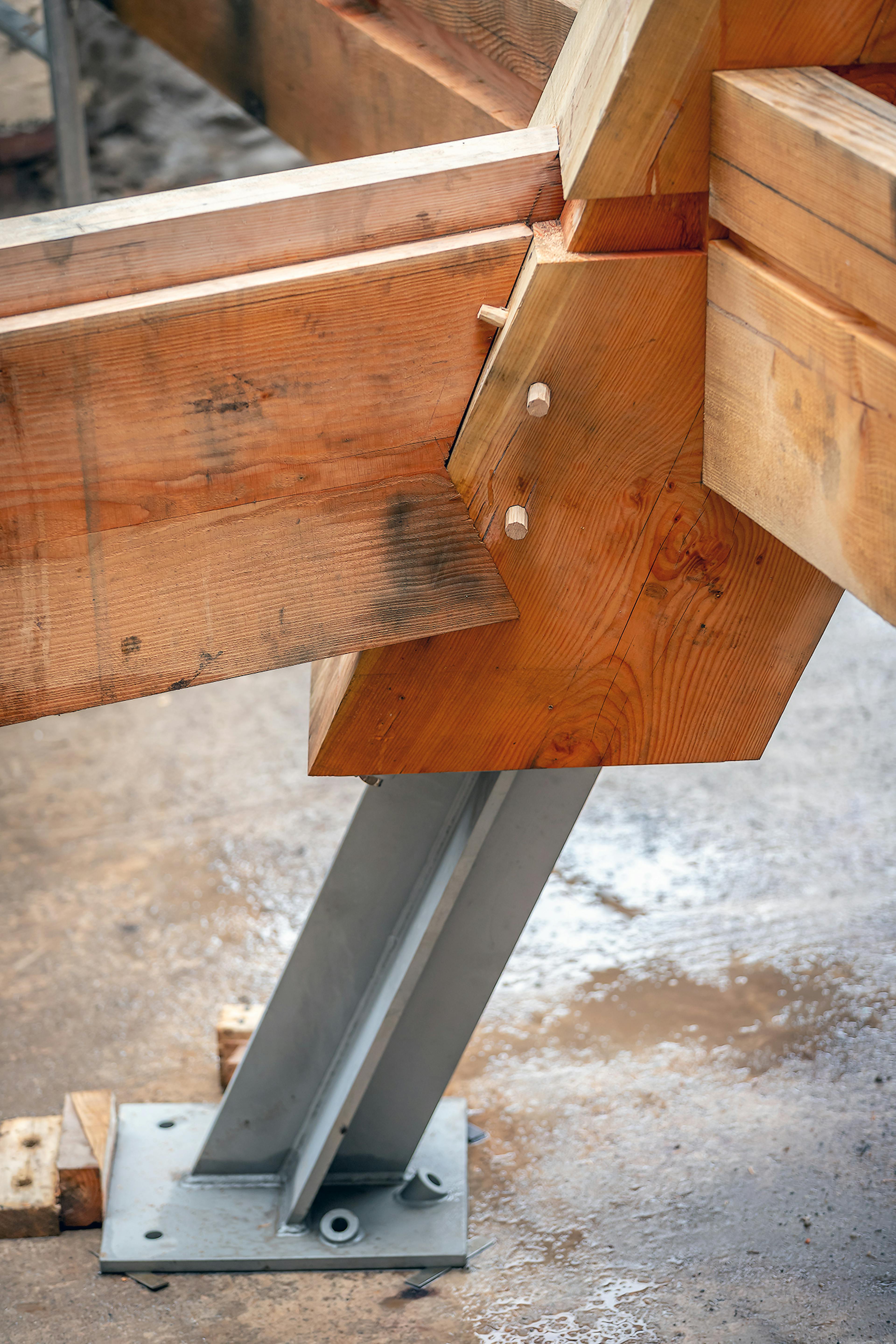 Central post being installed on-site for the Riverside Boathouse, secured with steel post feet and steel fixings, constructed from Douglas fir and larch