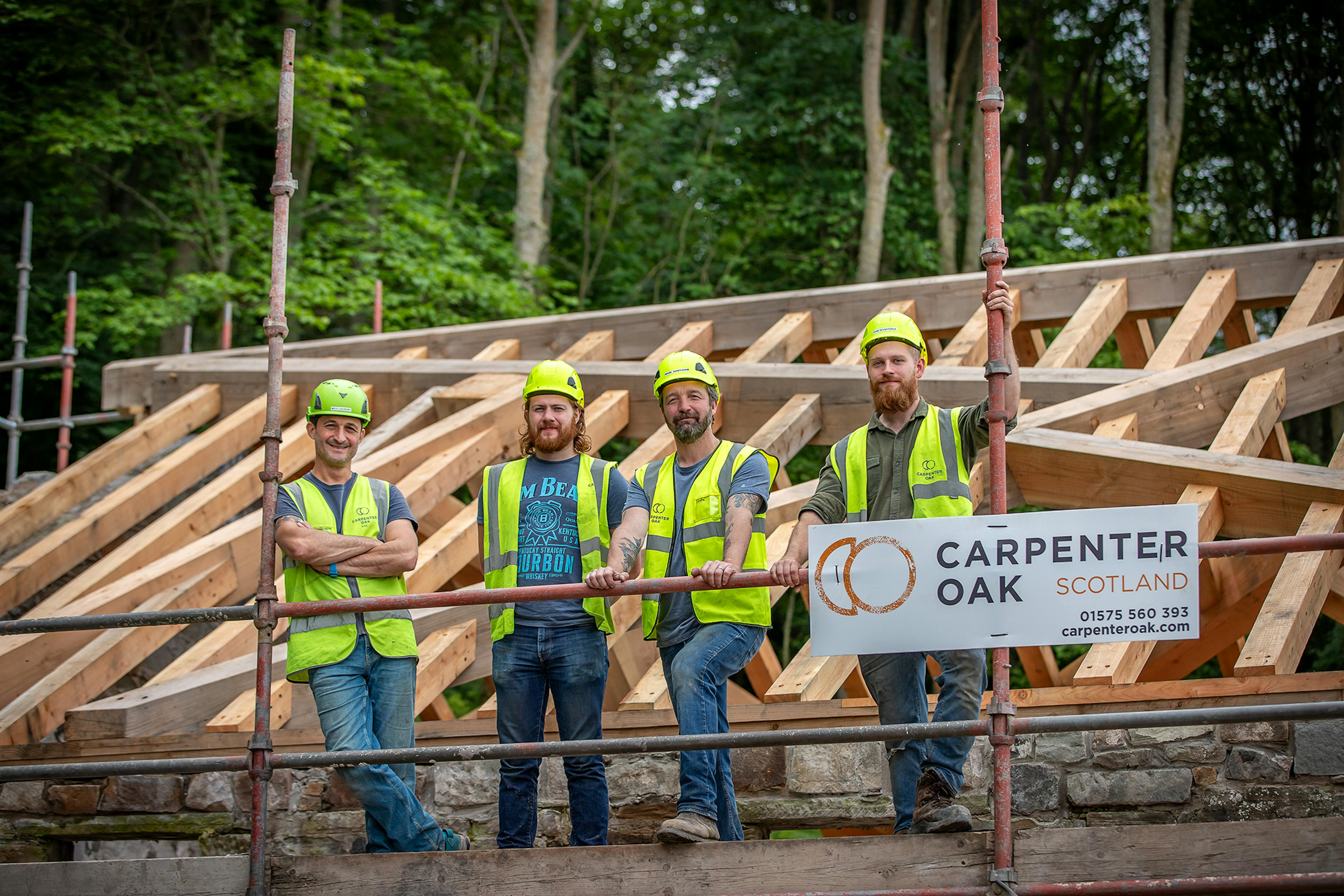 Construction team working on-site during the installation of the Riverside Boathouse, built with Douglas fir and larch timbers