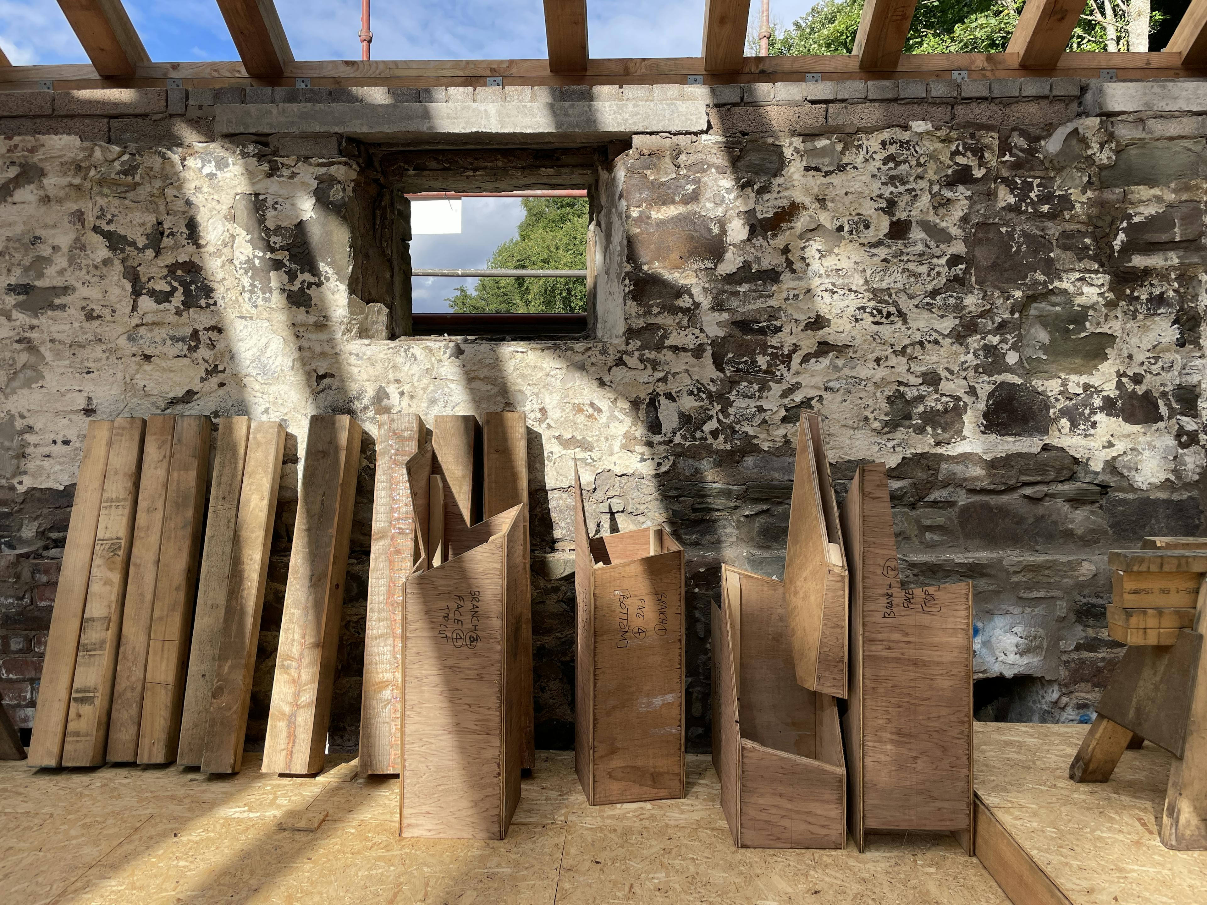 Cutting templates laid out on site during the installation of the Riverside Boathouse, using Douglas fir and larch timbers