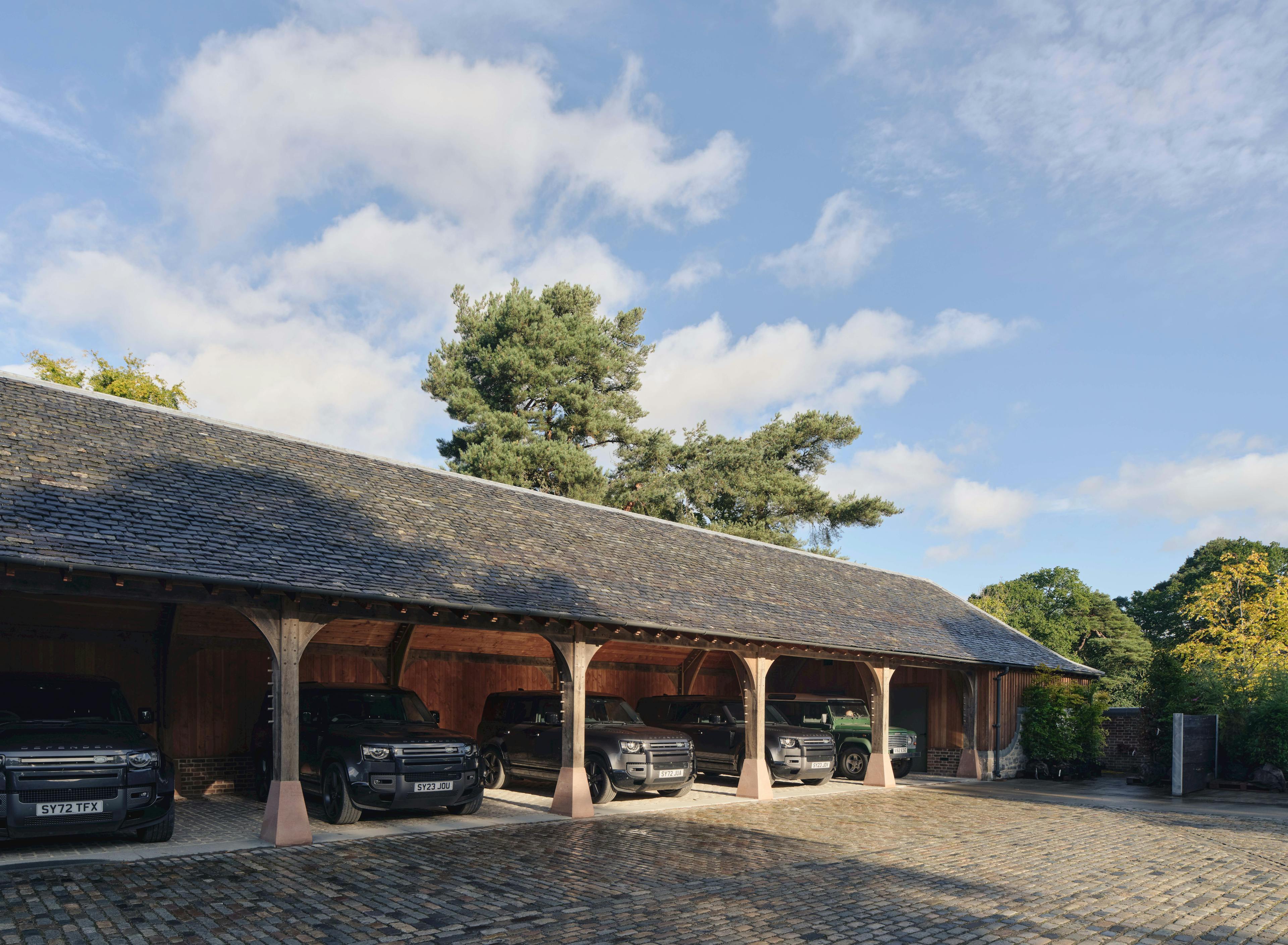 Timber-framed garage on Scotland’s Aldourie Estate, elevated on traditional concrete staddle stones