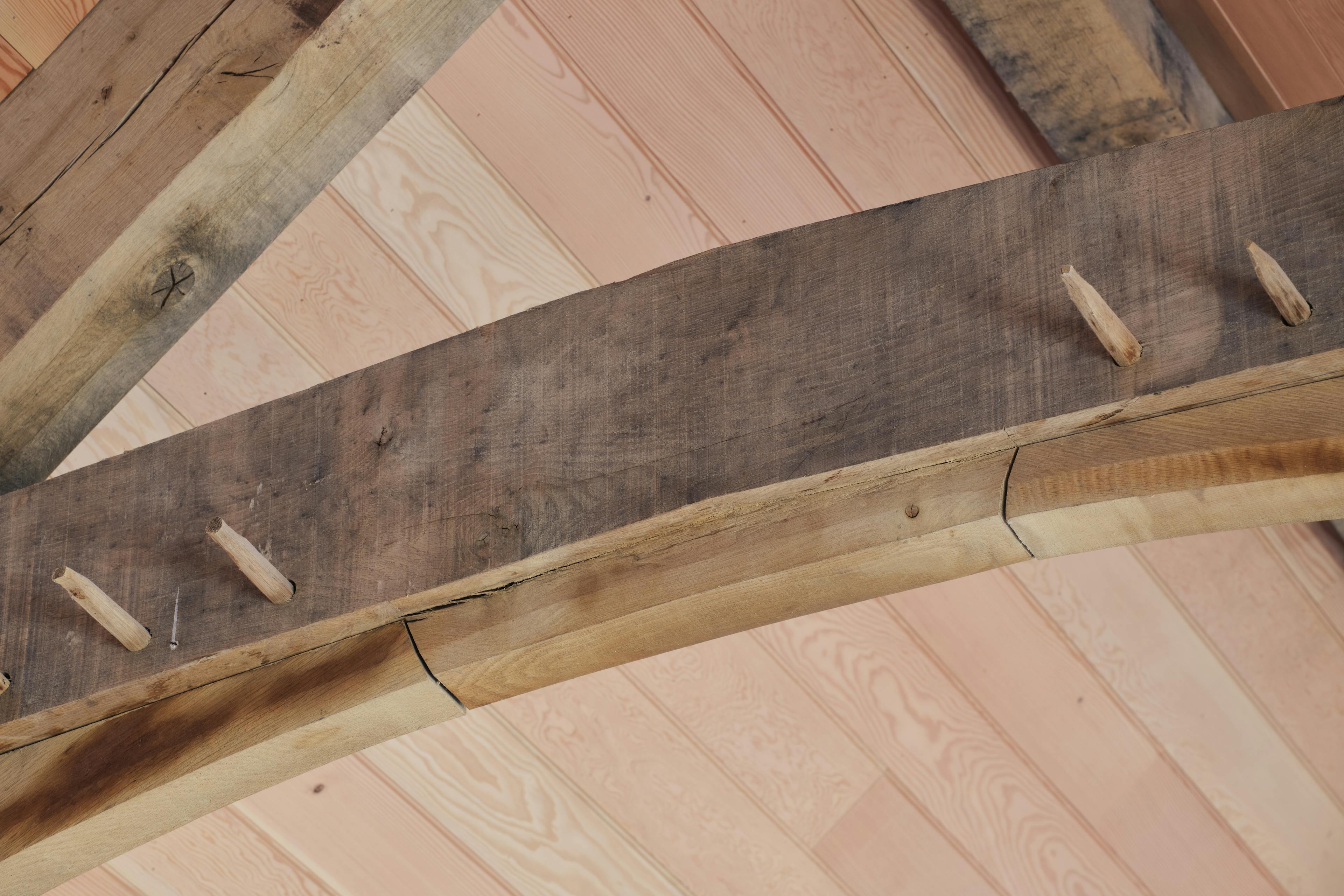 Finished oak frame trusses with Douglas fir cladding and tie beam details at the Home Farm Barns on the Aldourie Estate in Scotland