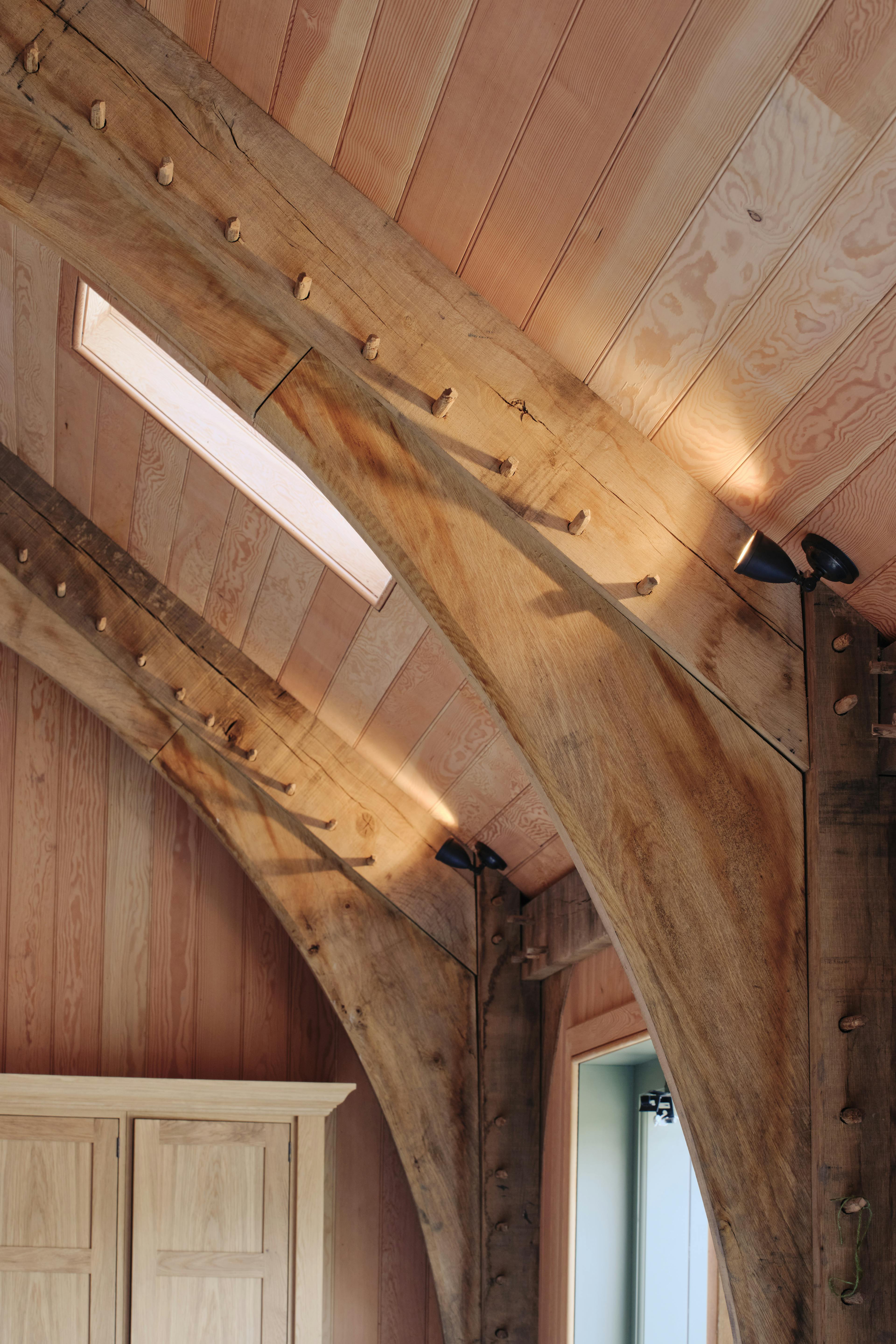 Internal oak frame trusses with Douglas fir cladding and brace structure at the Home Farm Barns on the Aldourie Estate in Scotland