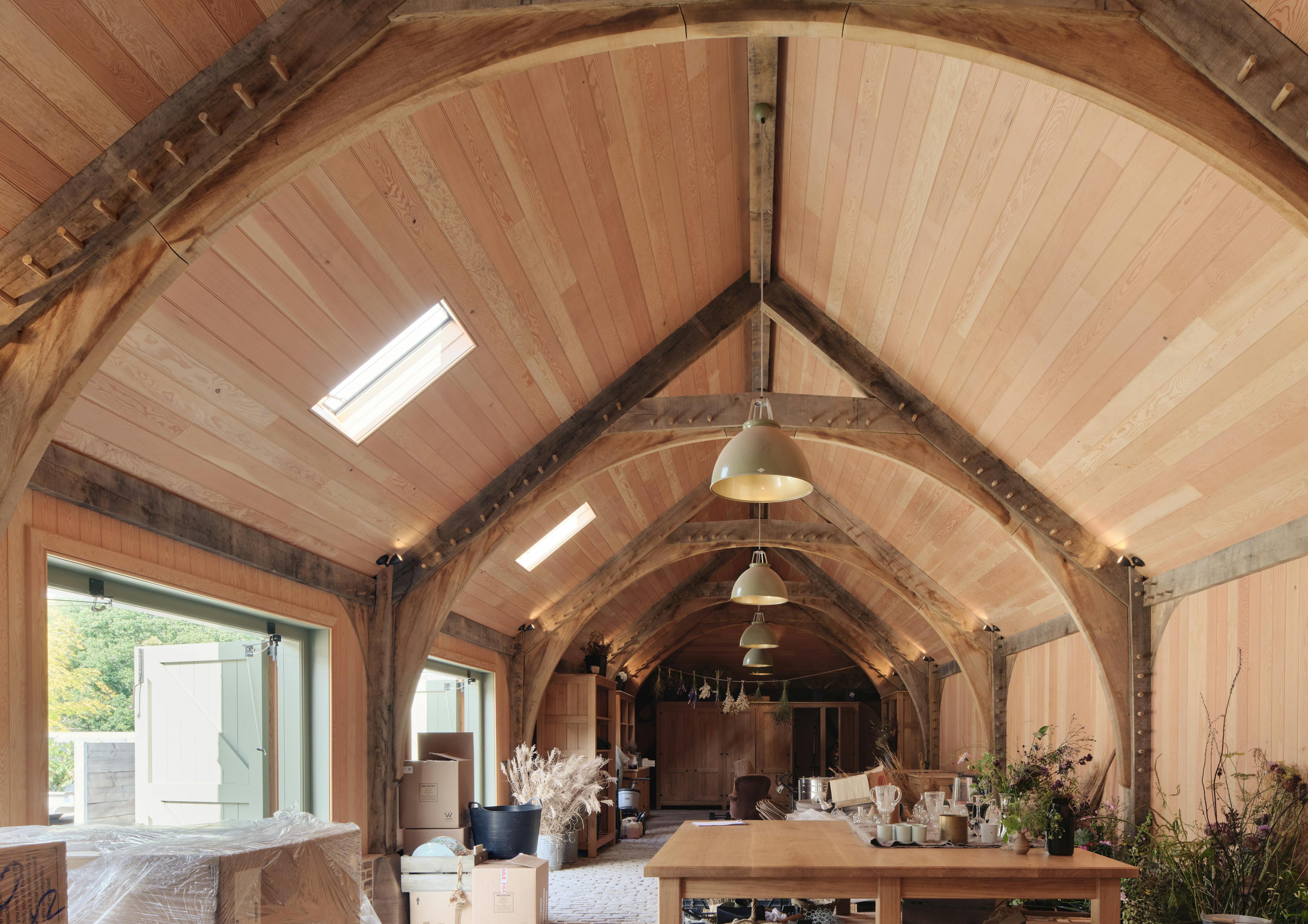 Internal oak frame trusses with Douglas fir cladding, pantry space, and peg details at the Home Farm Barns on the Aldourie Estate in Scotland
