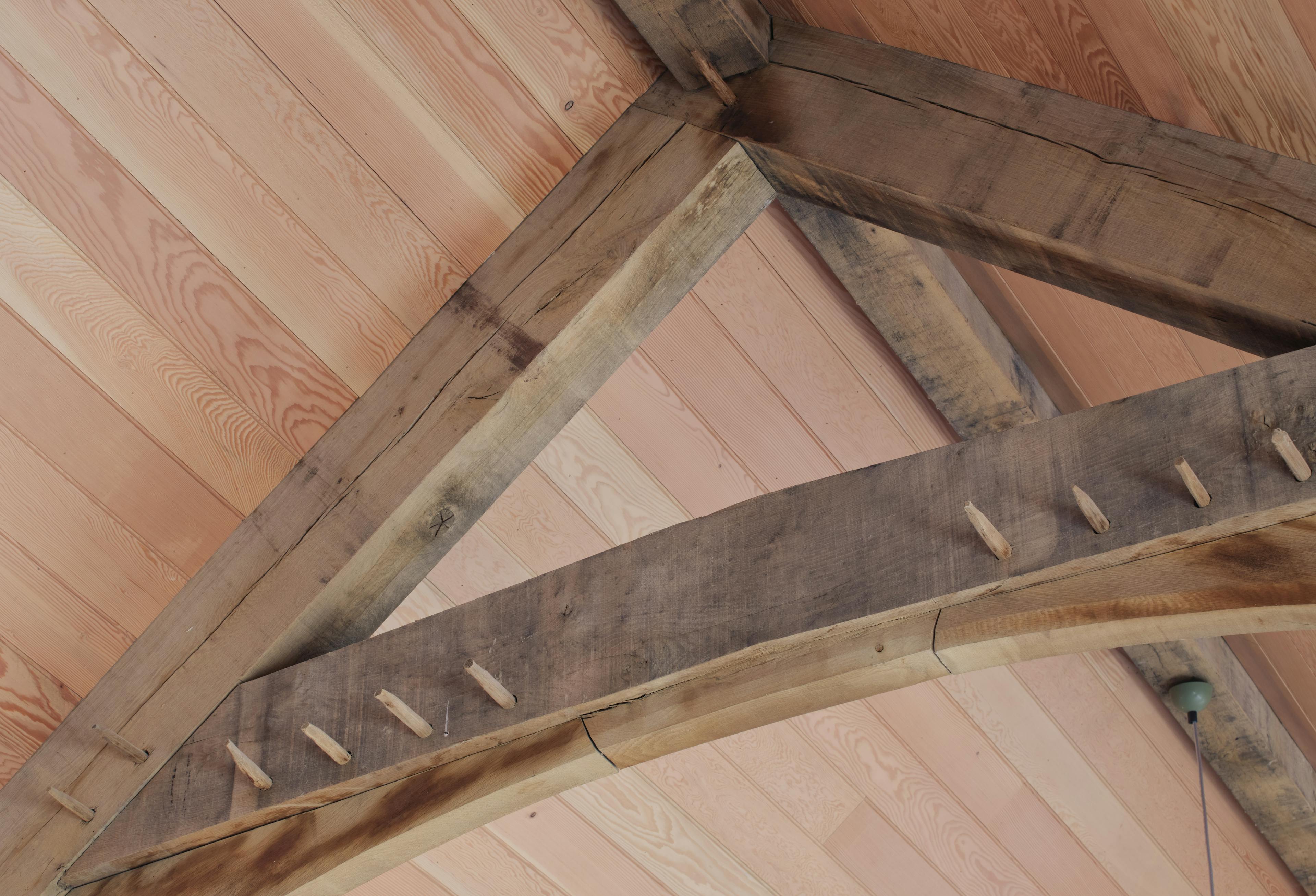 Internal oak frame truss joint with Douglas fir cladding at the Home Farm Barns on the Aldourie Estate in Scotland