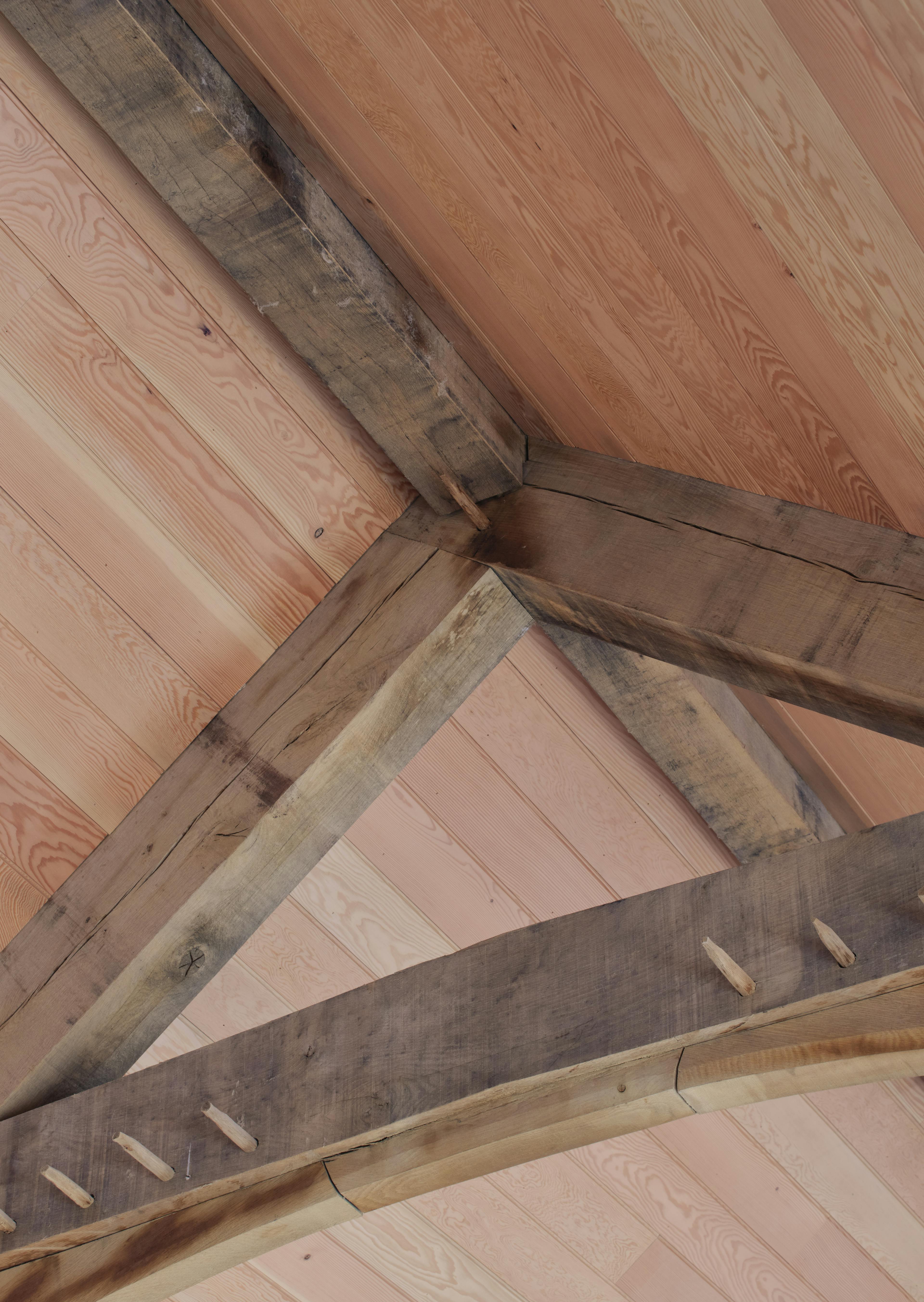 Internal oak frame truss joinery connection with Douglas fir cladding at the Home Farm Barns on the Aldourie Estate in Scotland