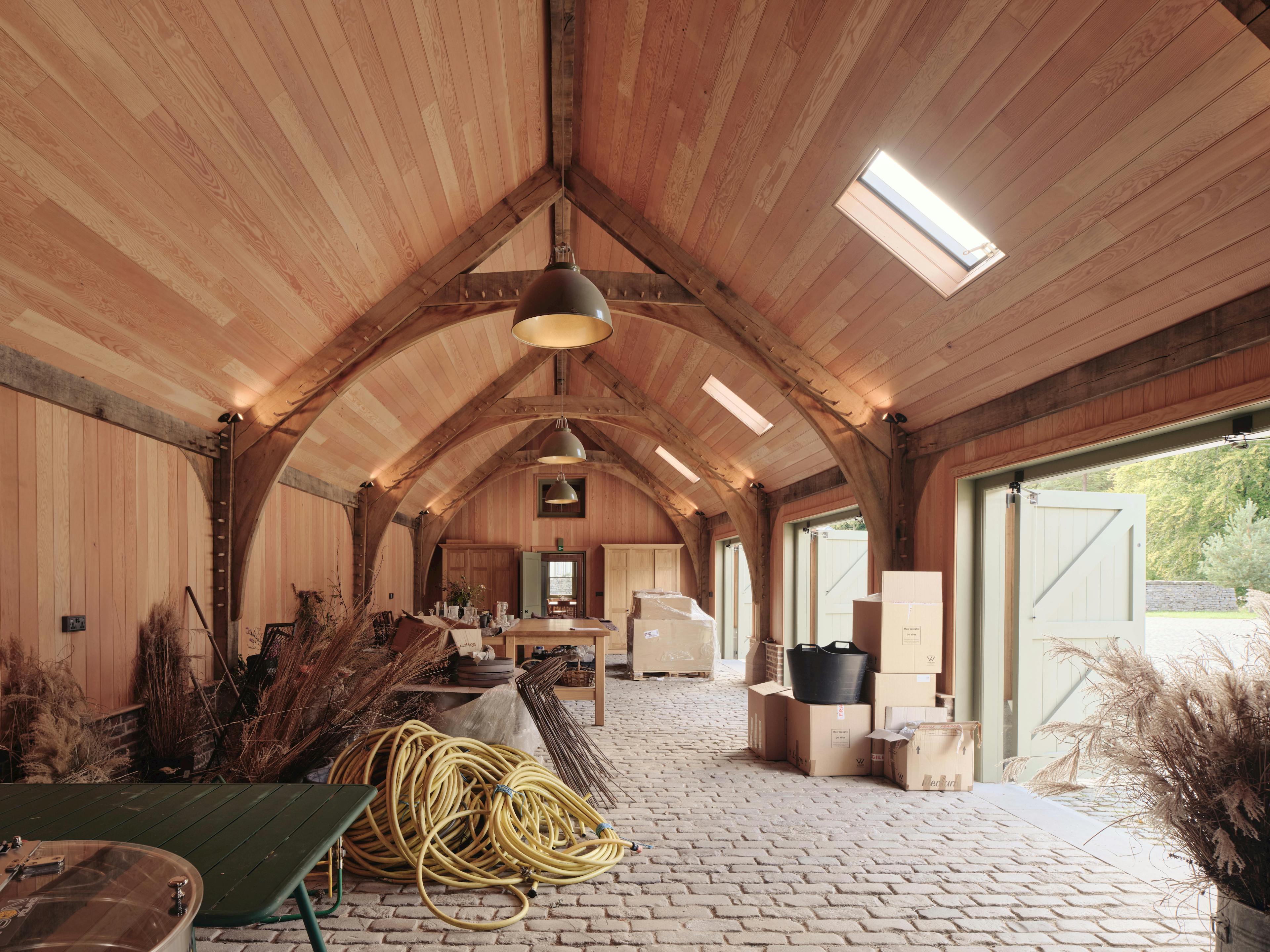 Interior of a traditional oak-framed barn used as a multi-purpose storage space
