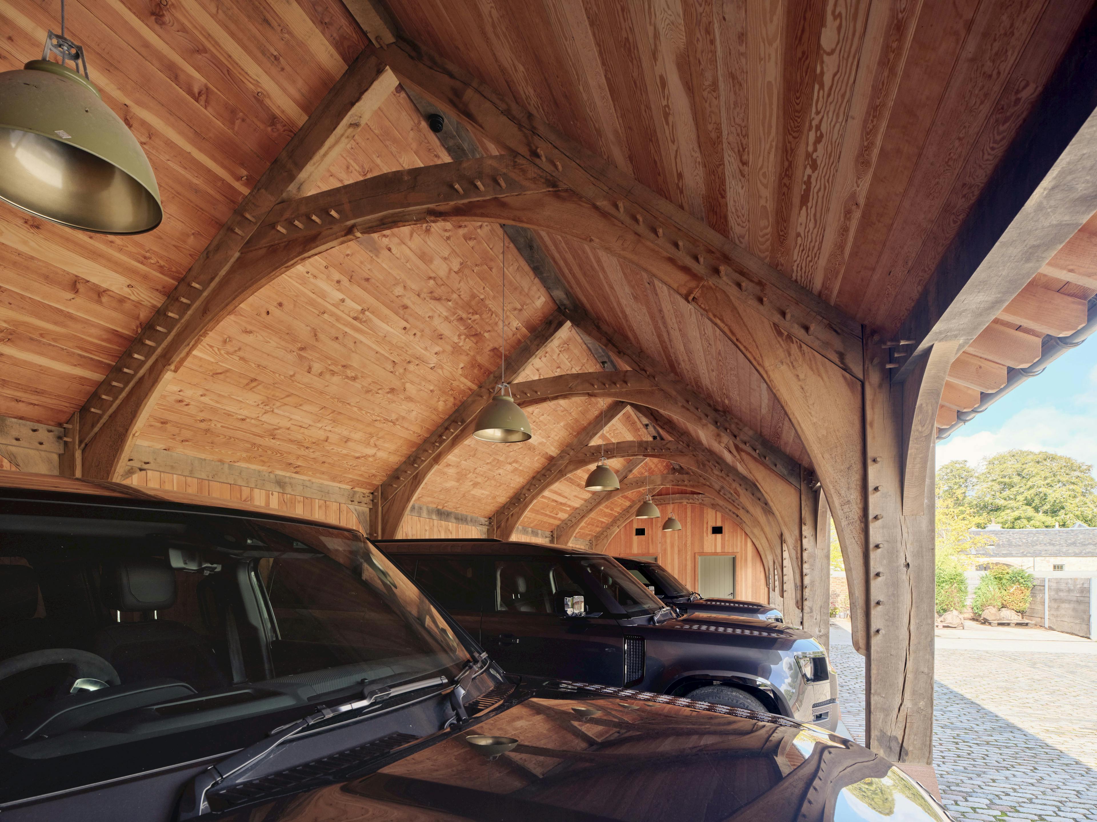 Interior view of a traditional oak-framed garage, showcasing the craftsmanship of its classic trusses