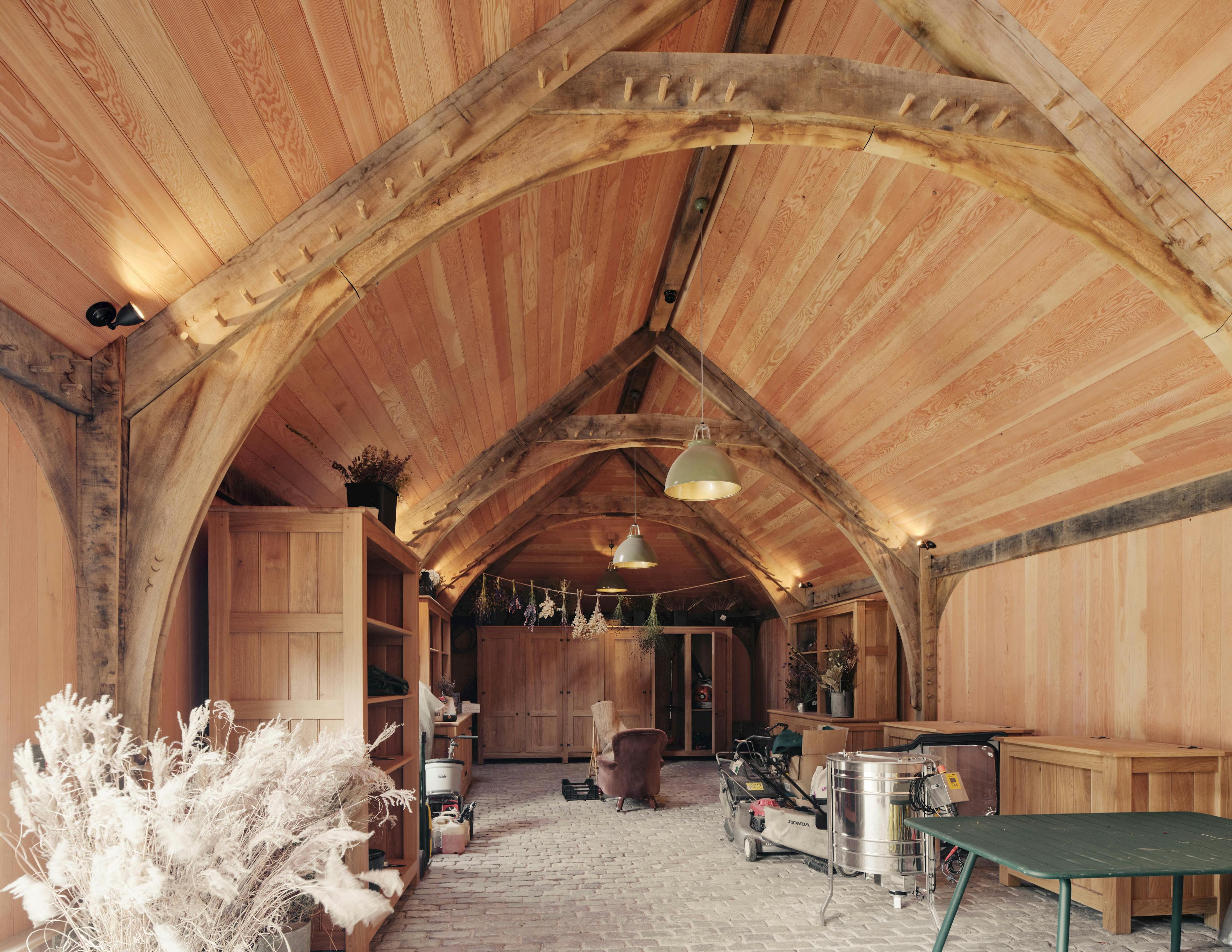 Interior of a traditional oak-framed space used as a multifunctional area, including a pantry for food storage 